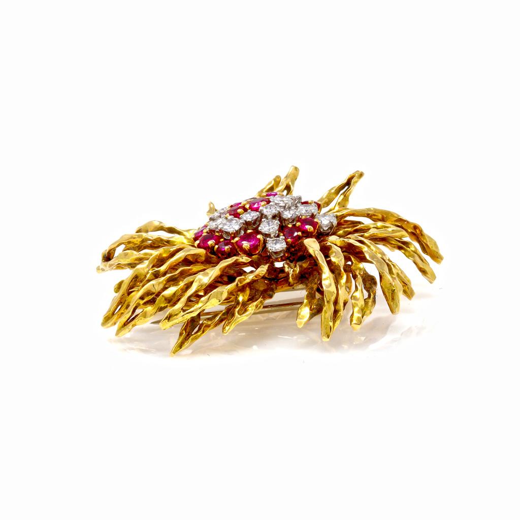 18 karat yellow gold, ruby and diamond brooch, French, circa 1960, of stylized floral design set in the center with round diamonds weighing approximately 1.50 carats, and round rubies weighing approximately 1.55 carats, gross weight 28.4 grams,