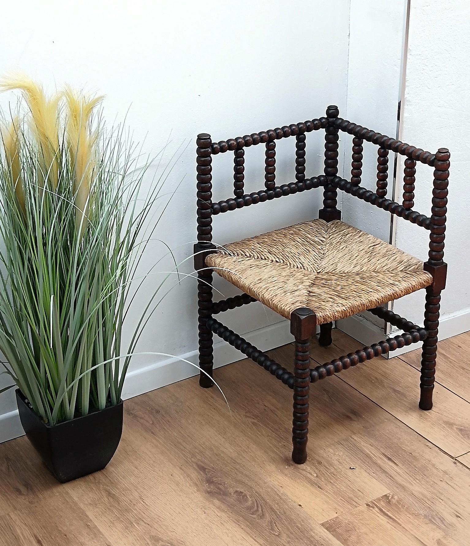 A charming dark wood stick and ball craftmanship corner chairs with original rush seat.