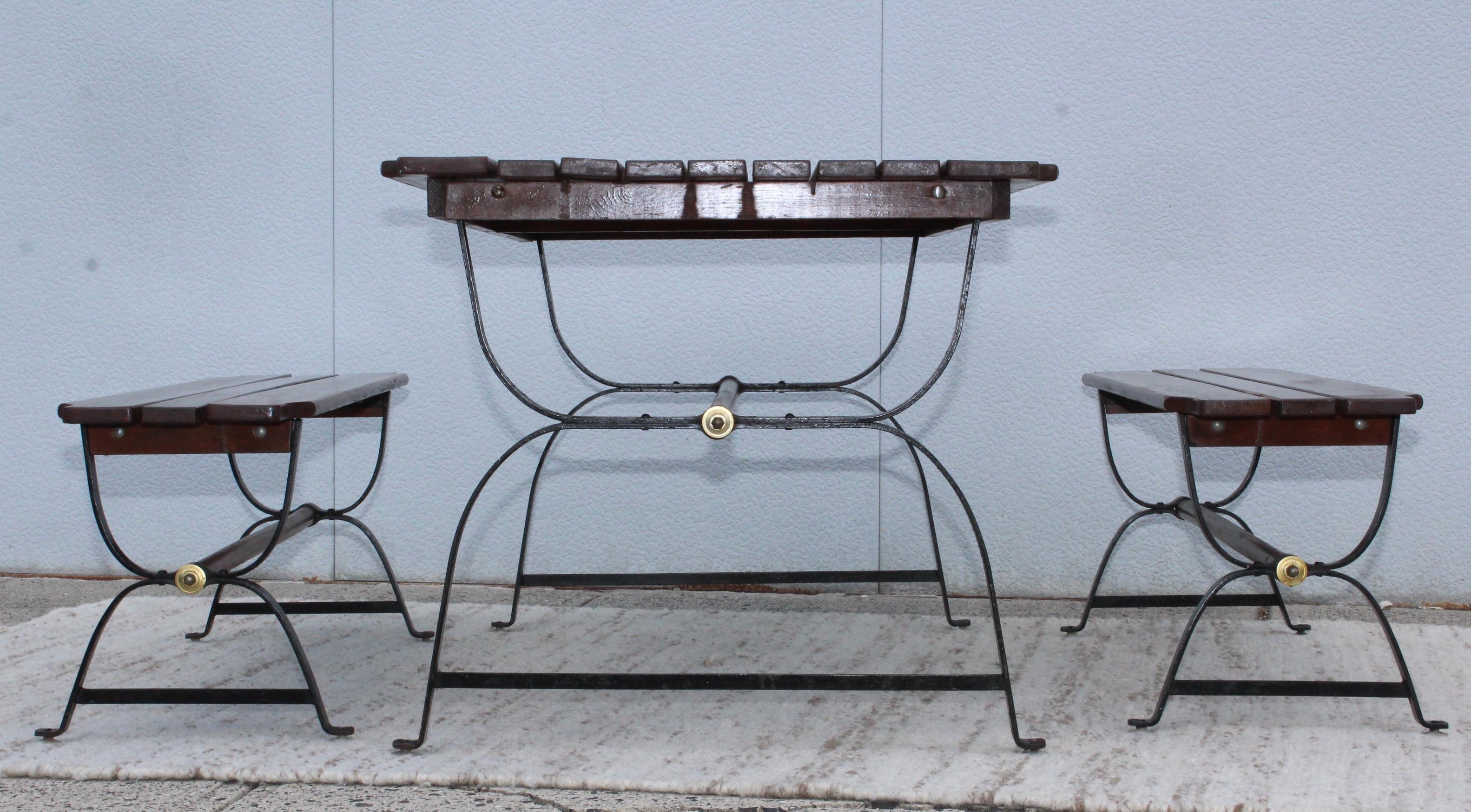 1960s modern French style iron and walnut well made indoor/outdoor dining table with matching nesting benches. In original condition with some wear and patina.

Benches measurements: Length 47.5”, depth 12.75, height 17”.