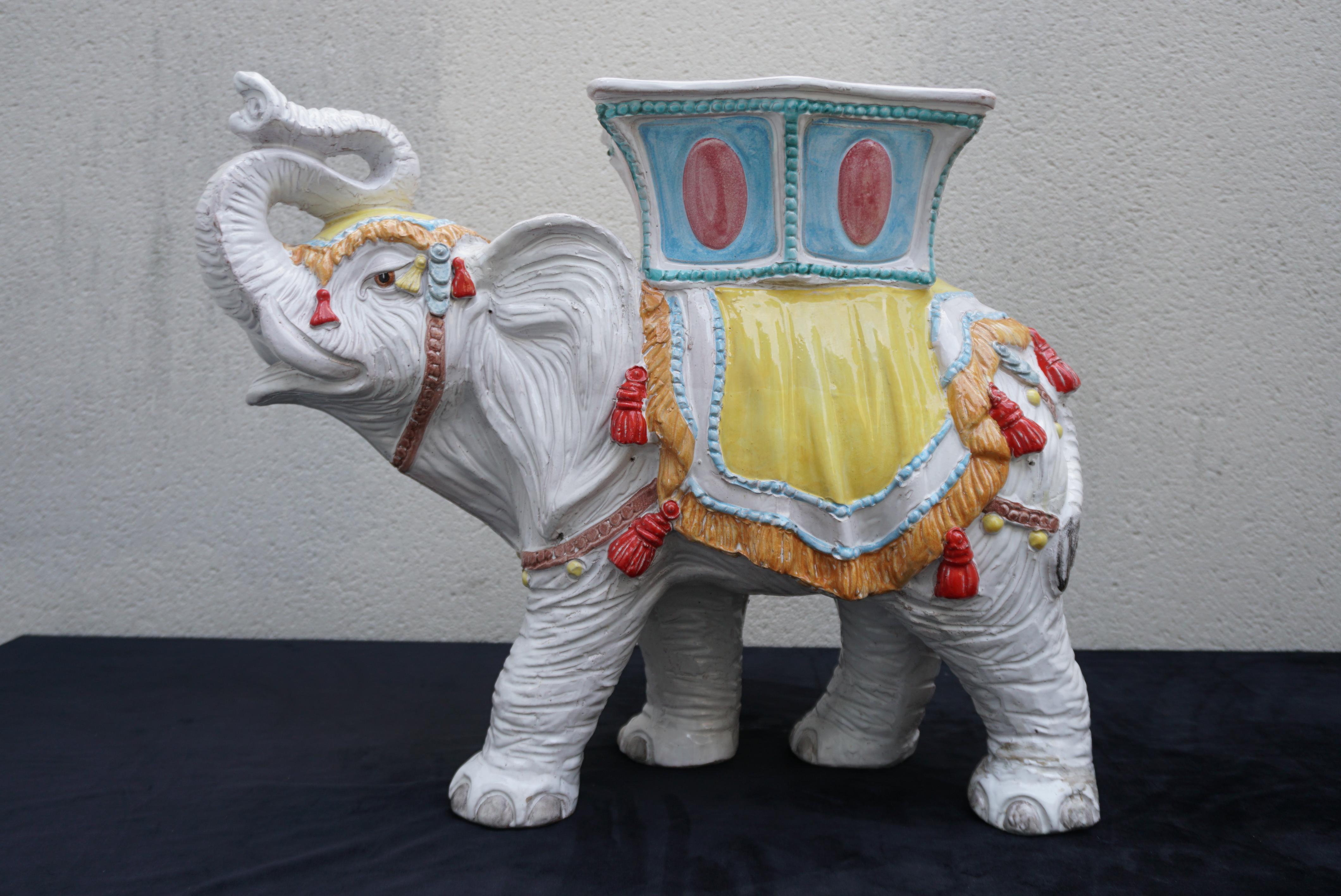 A ceramic terracotta decoration from 1960s Italy in the shape of an white elephant. Can be used as a plant stand or side table as well as a chair.

Weight 25 kg.
Width 27.1