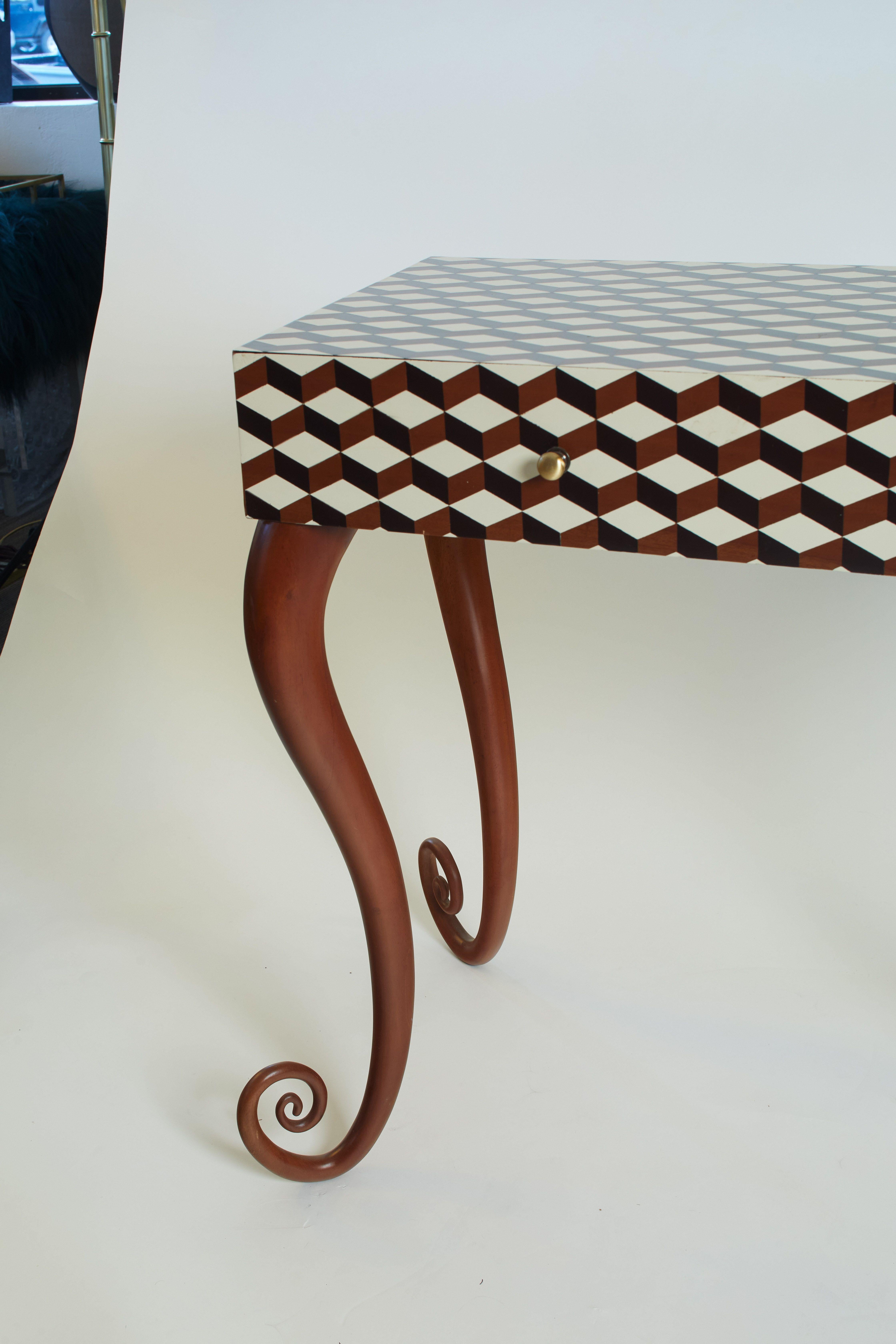 1960s French unique marquetry wood inlaid desk/vanity with a geometric black, brown, and white design. Curled feet on desk legs.