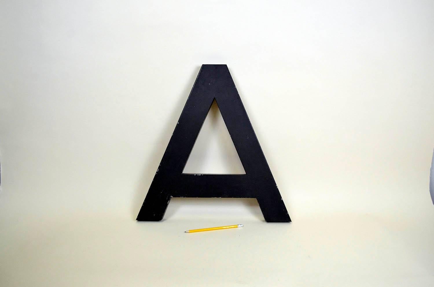 1960s French vintage metal letter A in dark brown outside and red inside.

 

 