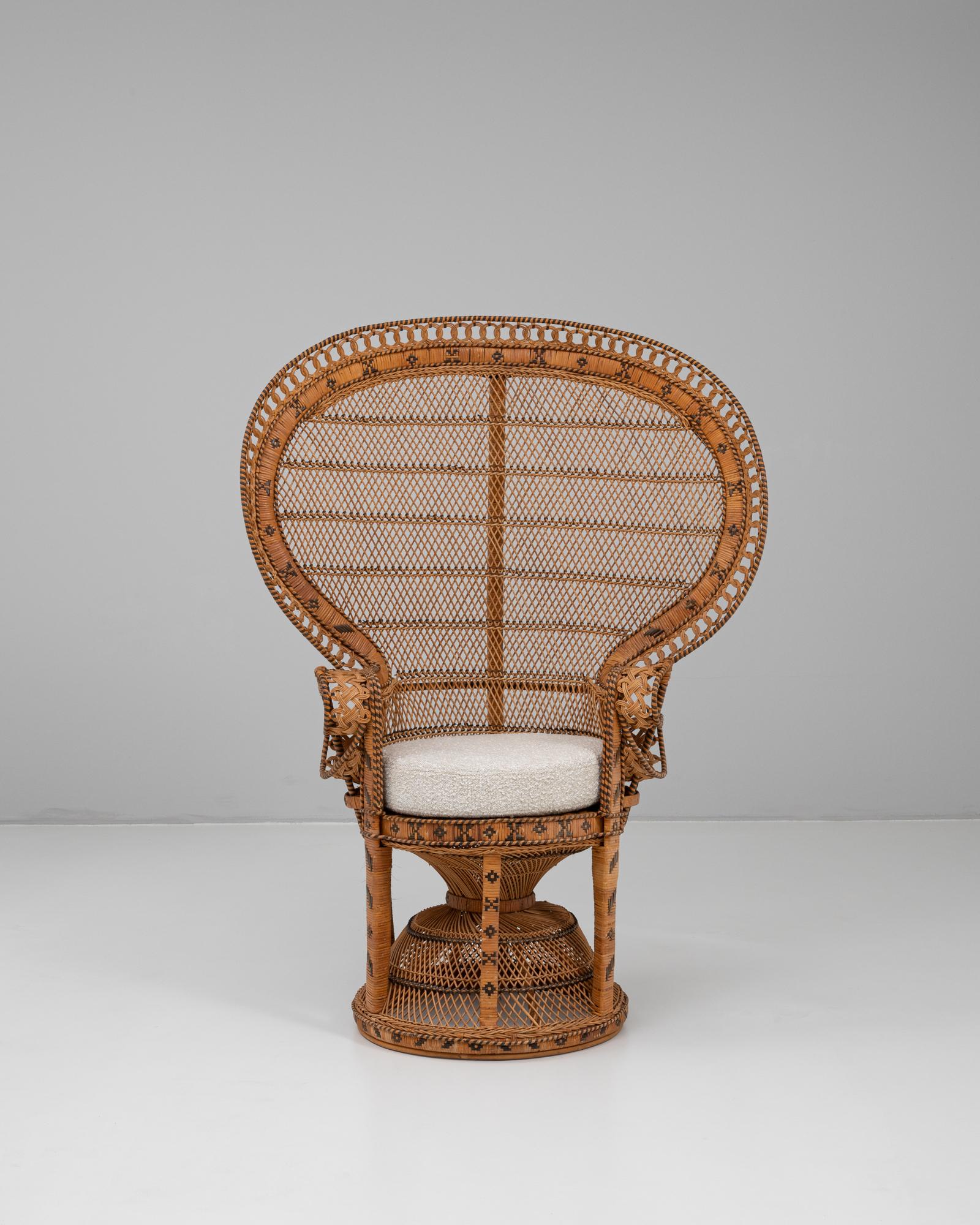 This 1960s French wicker peacock chair is a sculptural icon of bohemian design, defined by its dramatically fan-shaped back and intricate handwoven detailing. The natural wicker is interlaced with black accents, creating dynamic geometric patterns
