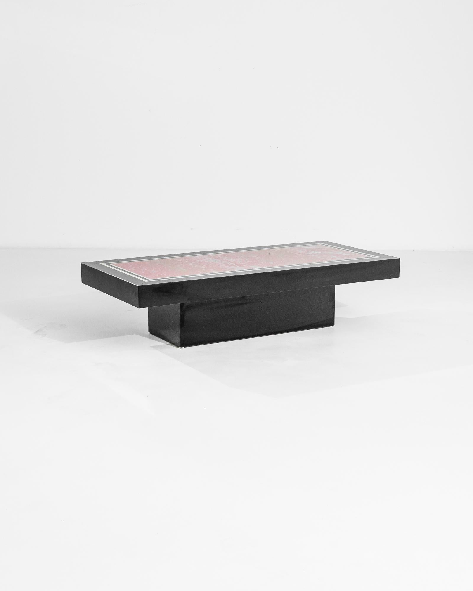 Cette table basse en bois de style français des années 1960 rehausse votre espace de vie. Affichant un design épuré et minimaliste, cette table présente une forme rectangulaire audacieuse avec une riche finition noire. Le plateau est orné d'une