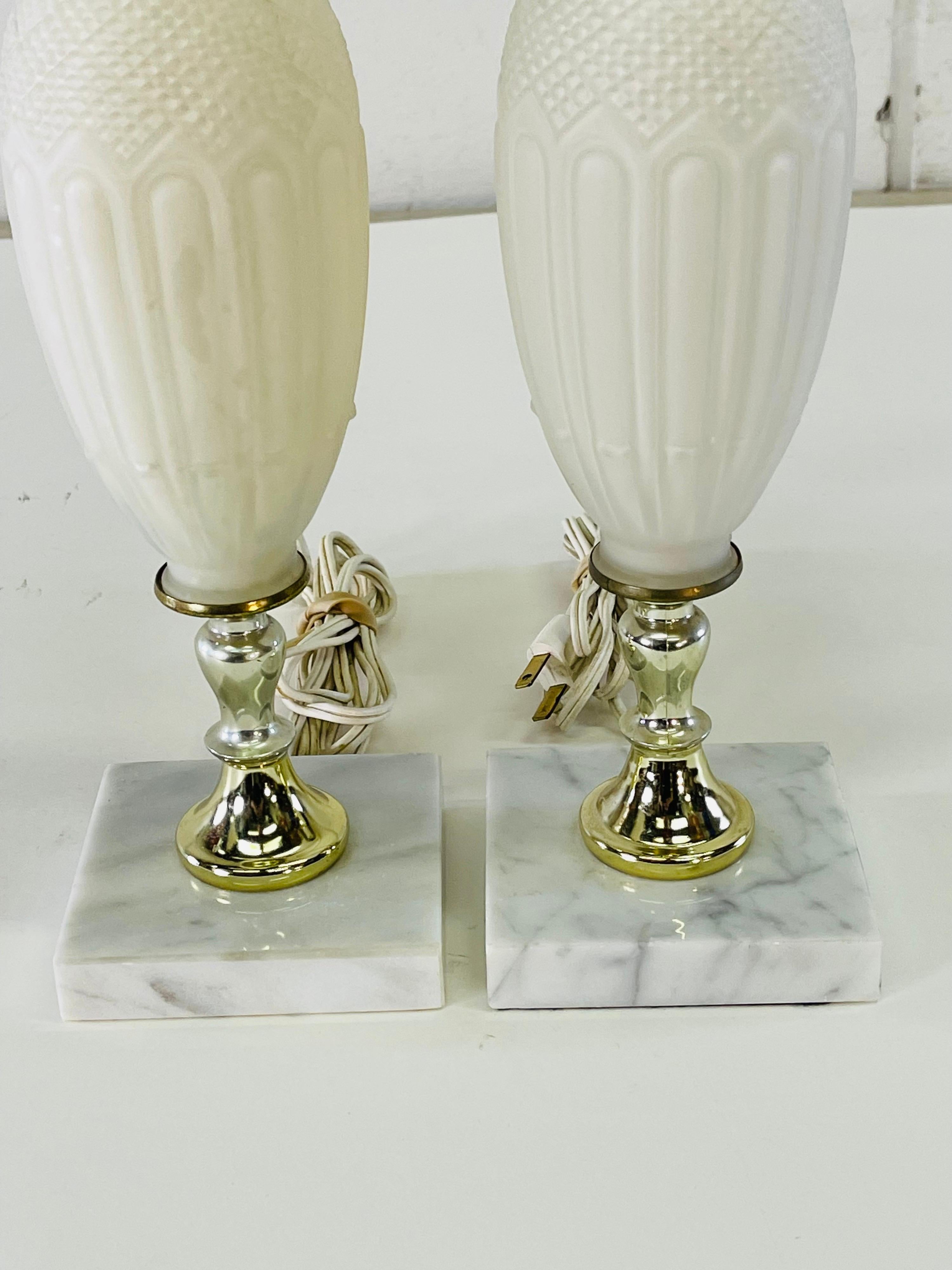 Vintage 1960s pair of frosted white glass table lamps with square marble bases. Wired for the US and in working condition. Socket, 18.5”H. Harp, 4” diameter x 9” height. Finials are plastic. No marks.