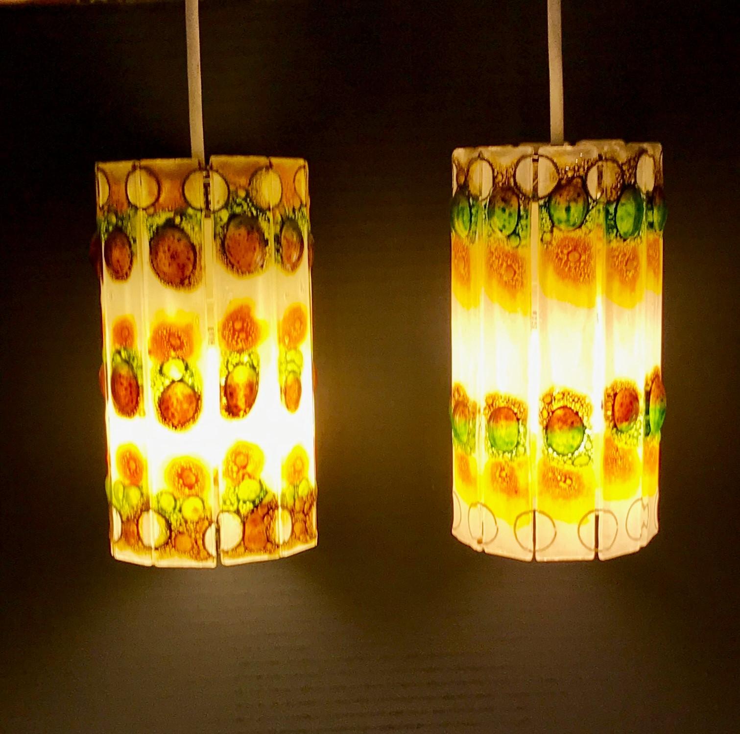 Modern 1960s Barrel Shaped Fused Art Glass Pendants. The pair in the style of Michael and Frances Higgins Studio glass, have been completely rewired with new UL porcelain sockets and 5 feet of cord that can be shortened if needed. Each Pendant's