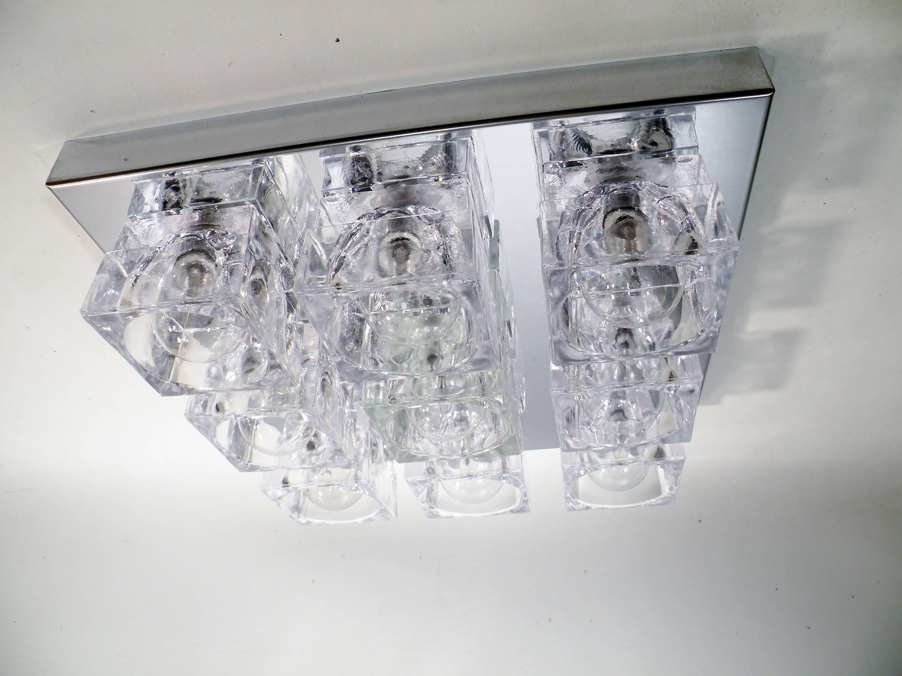 Square nine-light flush mounted sconce or ceiling lamp by Gaetano Sciolari, dating to the 1960s. This original example has nine square crystal cubes on chrome-plated steel mounting plate. Listed price is per fixture or lamp. Can be hung on ceiling