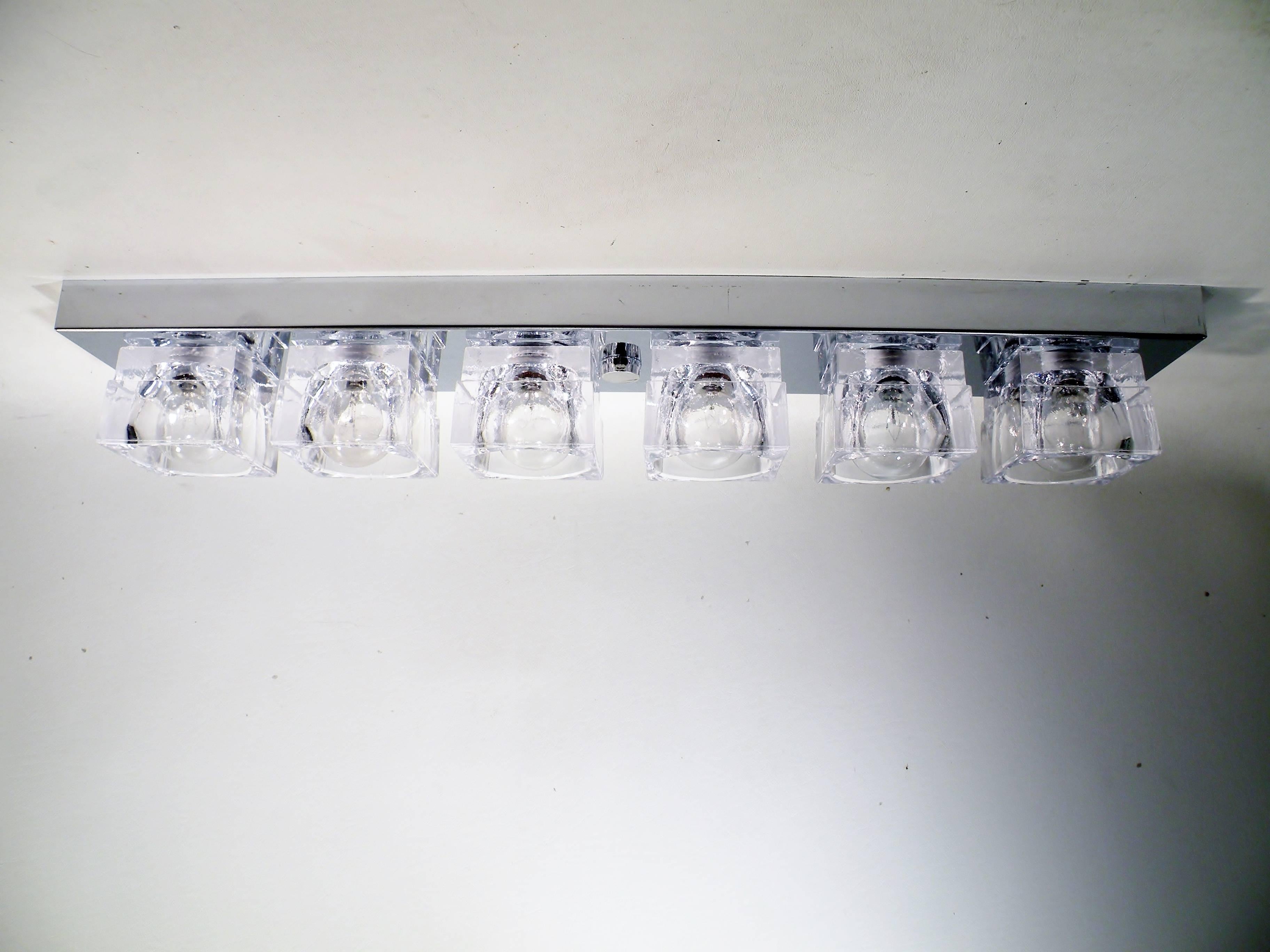 Flush mounted sconce or ceiling lamp by Gaetano Sciolari, dating to the 1960s. This original example has six square crystal cubes on chrome-plated steel strip mounting plate. Price listed is per sconce. Can be hung vertically or horizontally, at