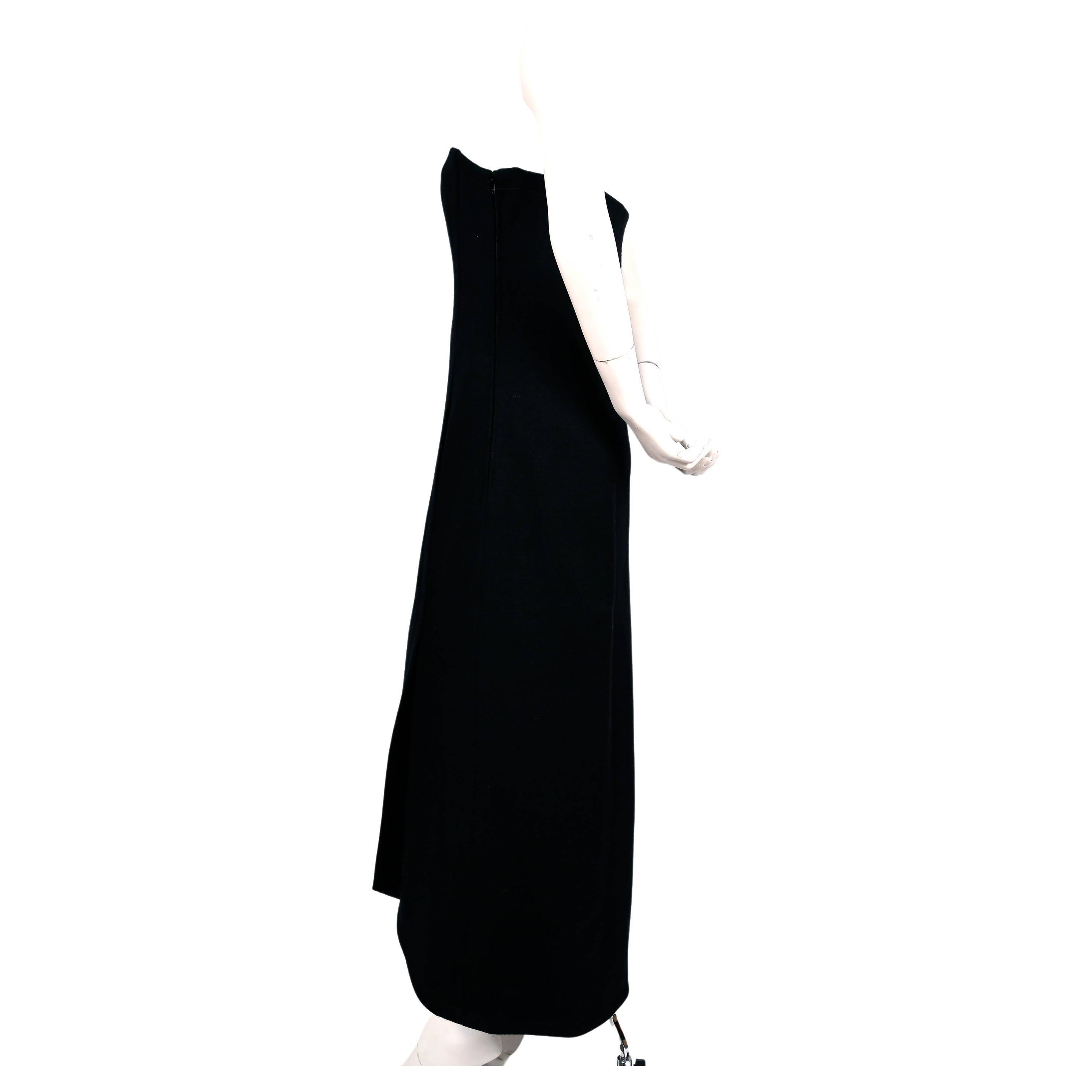 Very chic, jet-black, wool jersey strapless dress with internal corset and silk lining from James Galanos dating to the 1960's. Dress has very unique asymmetrical seaming and hemline. Also has a secret slash pocket hidden by seam at front. Fits