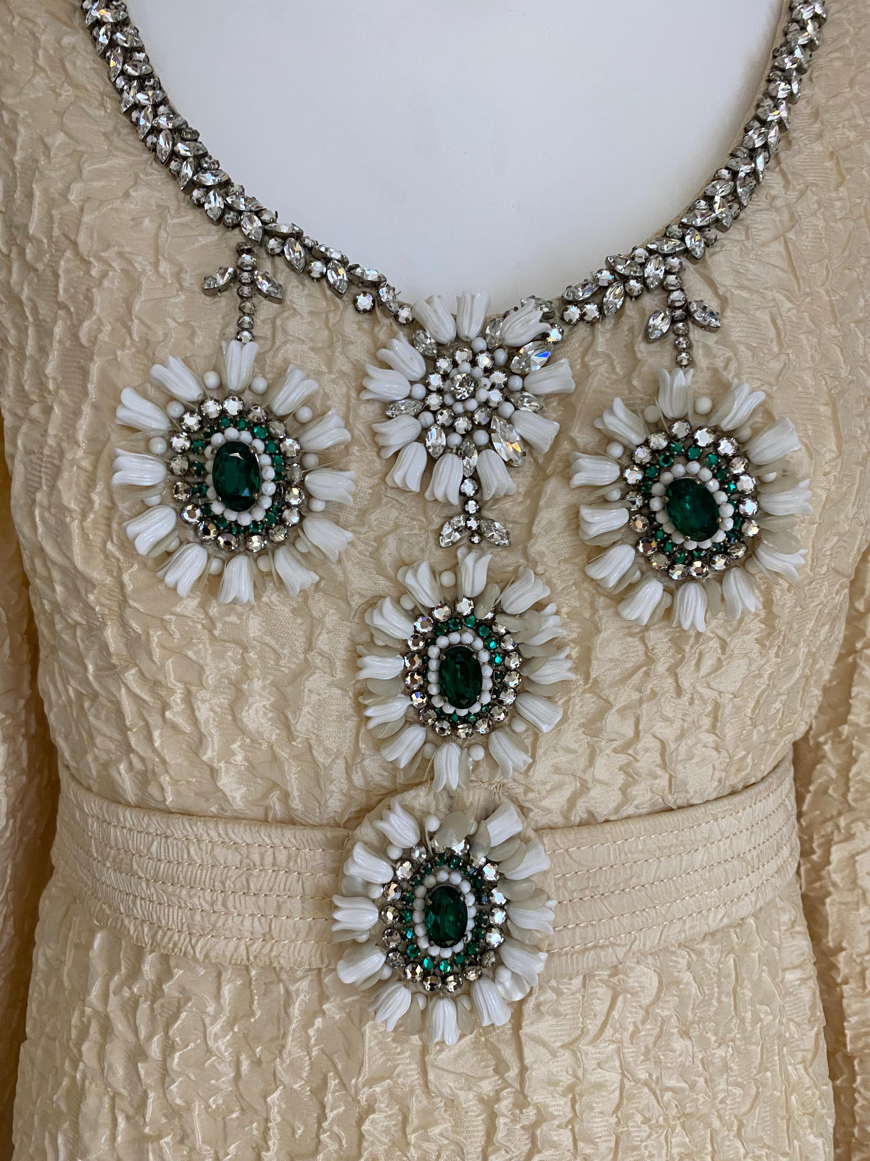 1960s James Galanos from Amelia Gray Boutique Creme silk crinkle long sleeve dress embellished in green rhinestones and white beads.
Dress has some issues on the arm pit . ( see image attached) For Design purpose or study.
Size 2