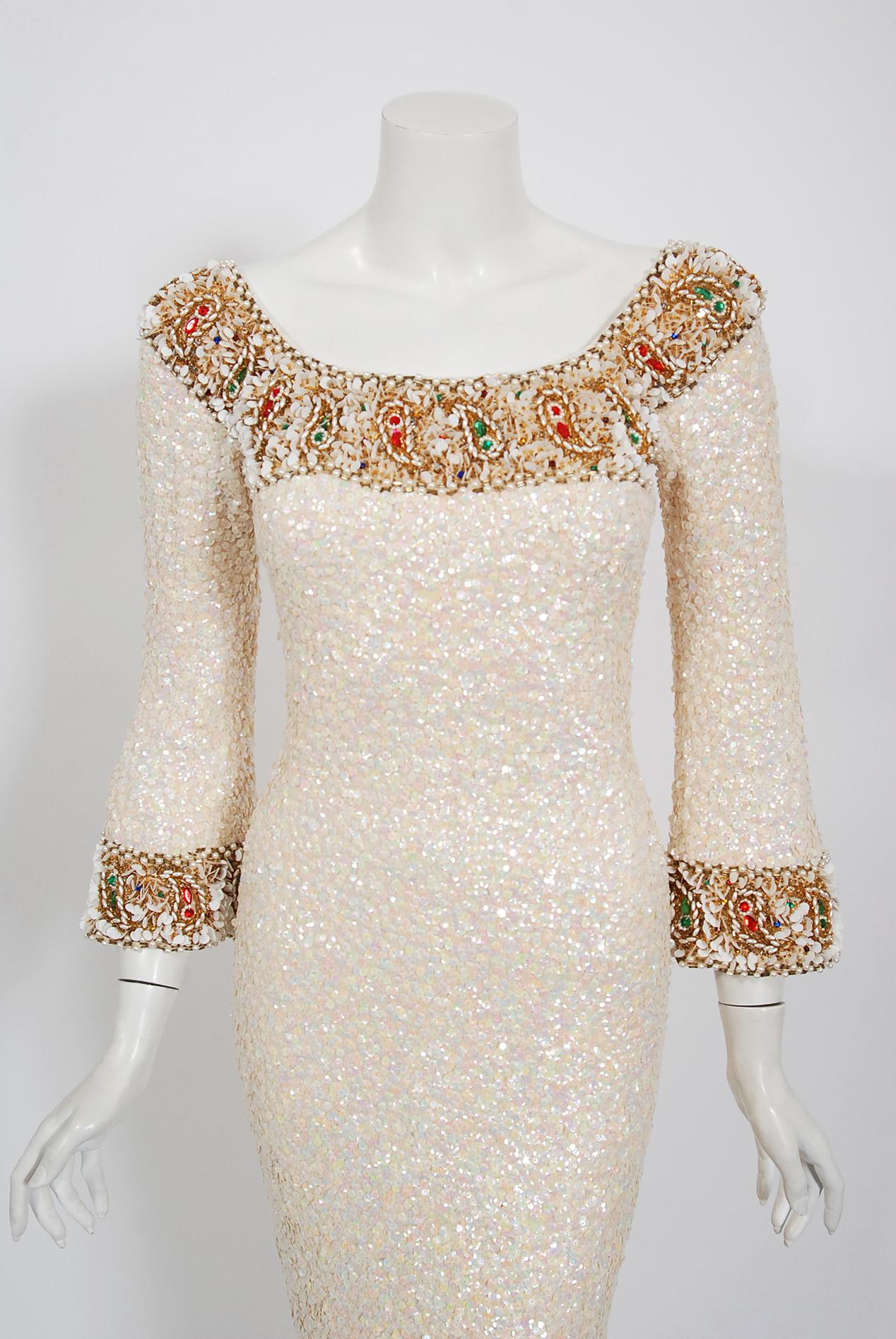 Mid-century Gene Shelly designer garments are in a class of their own. They are always fully-beaded by hand and fit to flatter the figure. This early 1960's treasure is fashioned in the most stunning ivory creme color, featuring iridescent sequins.