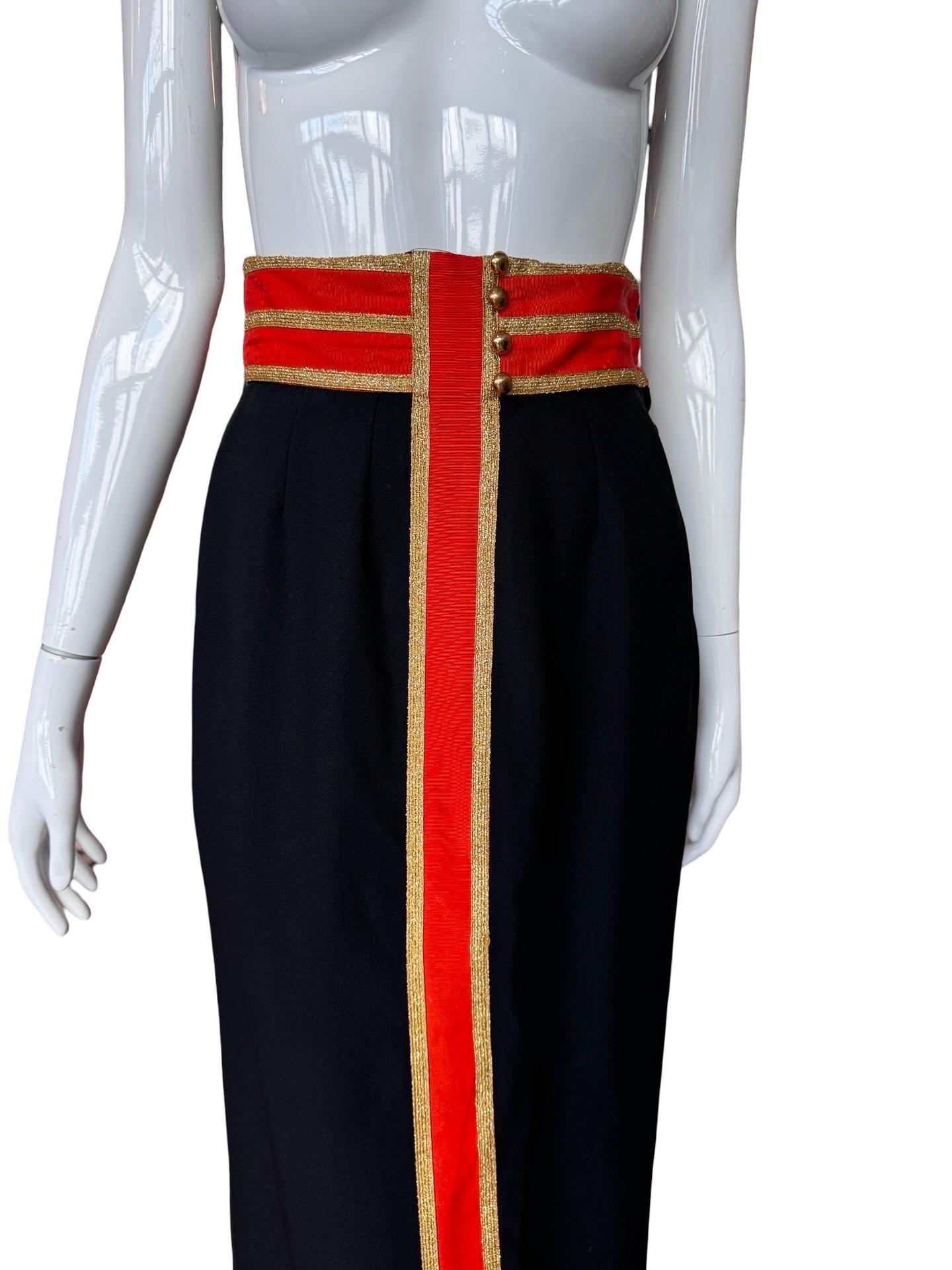 Geoffrey Beene skirt from a 1960s spin off collection 'Beene Bazaar' in black wool with orange grosgrain ribbon down the center and around the waist with gold thread trim detail and gold buttons.  There is some damage to the integrity of the orange