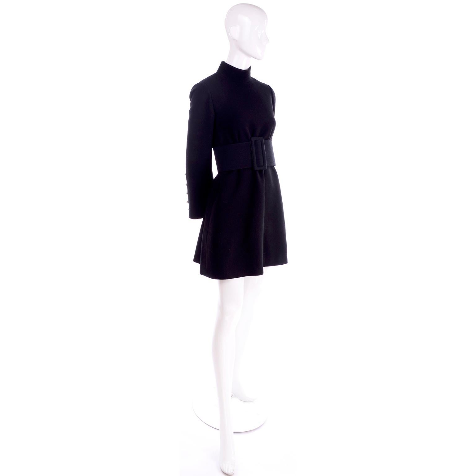 We love Geoffrey Beene and this is an iconic Geoffrey beene dress from the 1960's. This black wool mini dress has an oversized matching black thick belt. This dress fits like a 4/6 in a tent or swing style and can be worn with or without the belt. .