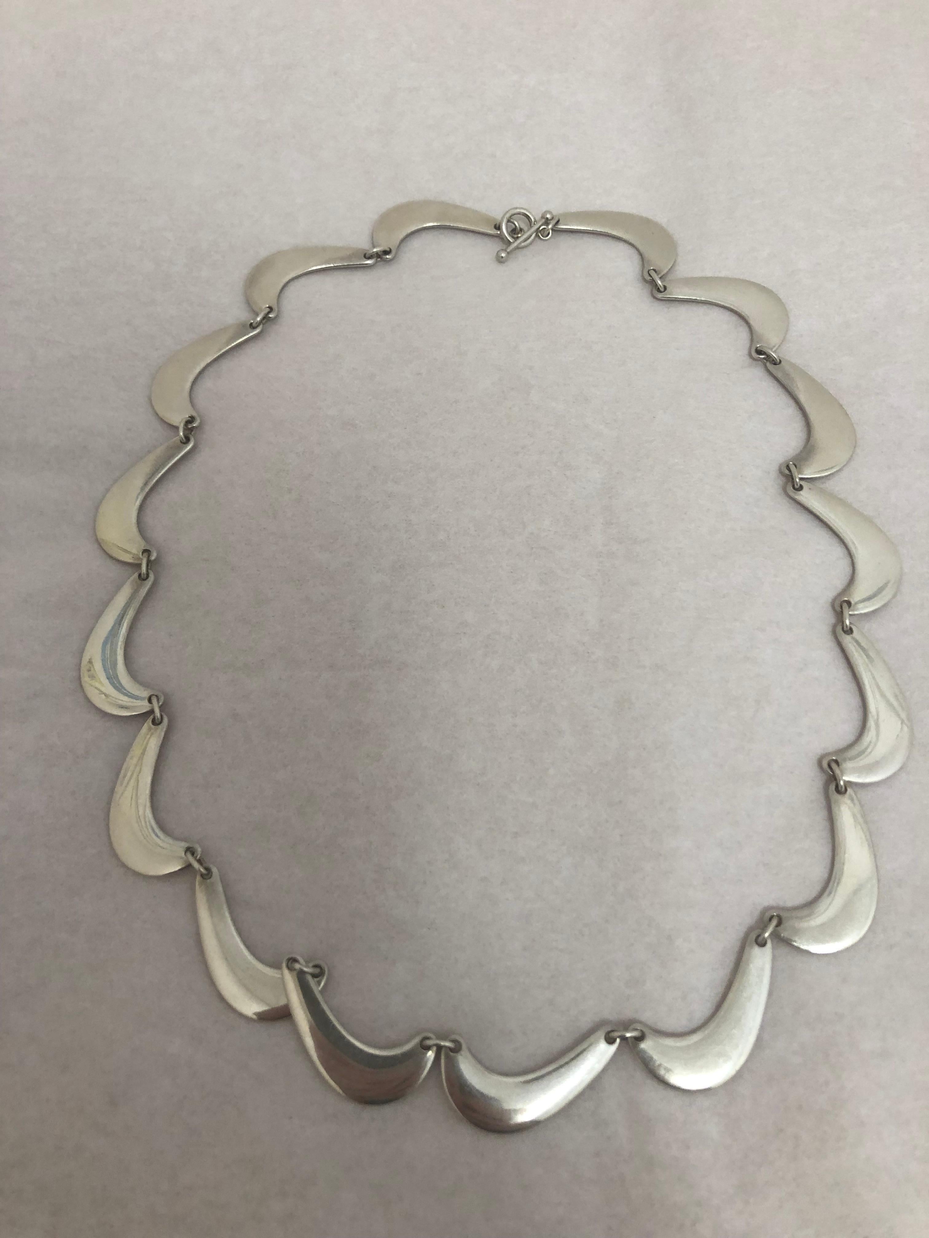 This is a modernist piece designed by Nanna Ditzel for Georg Jensen in the 1960s. It is made of 925 silver; has a toggle closure, and is engraved 925 S Denmark, Georg Jensen and 276.

We are resellers and do not lay claim to any copyright which is