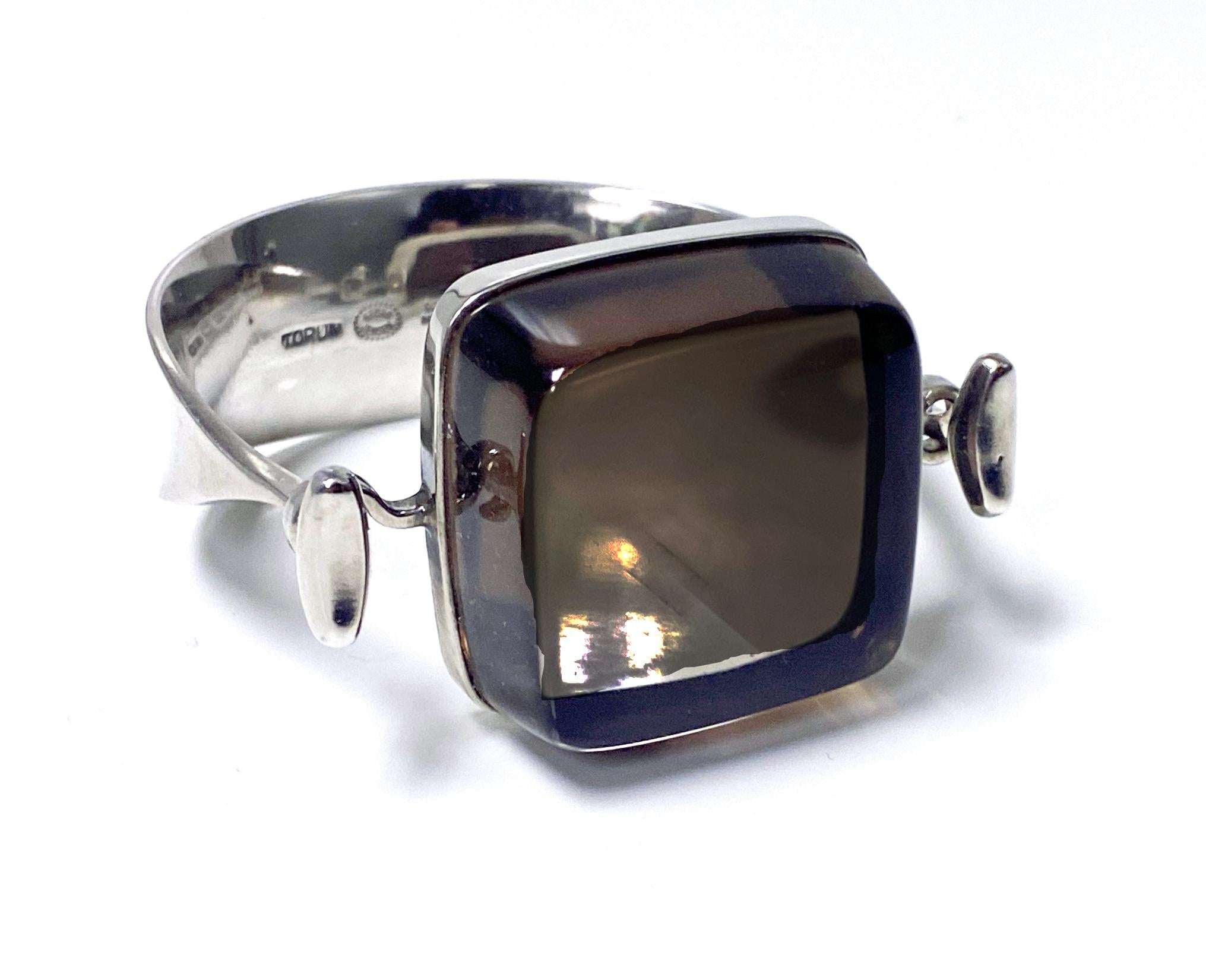 Georg Jensen Bangle with smoky rock crystal model # 203B Designed by Vivianna Torun Bülow-Hübe C. 1969. Sterling Silver extremely rare design. Fits most wrists up to 7 inches, tension clamp opening. Approximate dimensions: bangle circumference