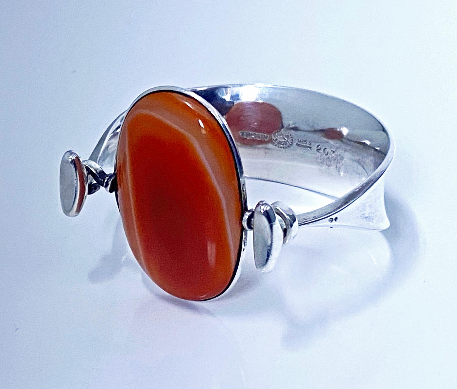 Georg Jensen Bangle with rare banded Red Agate model # 203 Designed by Vivianna Torun Bülow-Hübe C. 1969. Sterling Silver extremely rare design in red agate. Fits most wrists up to 6.5-7.0 inches, tension clamp opening. Approximate dimensions: