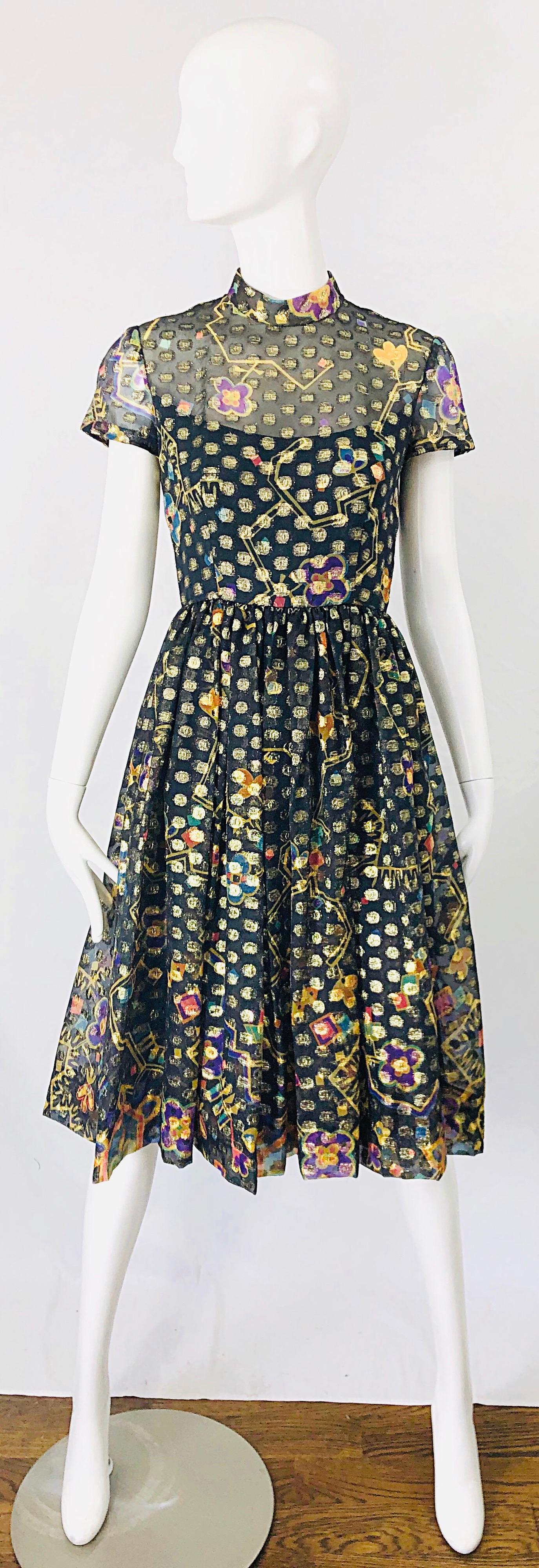 Beautiful late 1960s GEORGE HALLEY silk chiffon short sleeve dress ! Features a chiffon overlay with gold lurex polka dots throughout.Brightly colored flowers in purple, yellow, orange, pink, green, turquoise blue throughout. Full metal zipper up