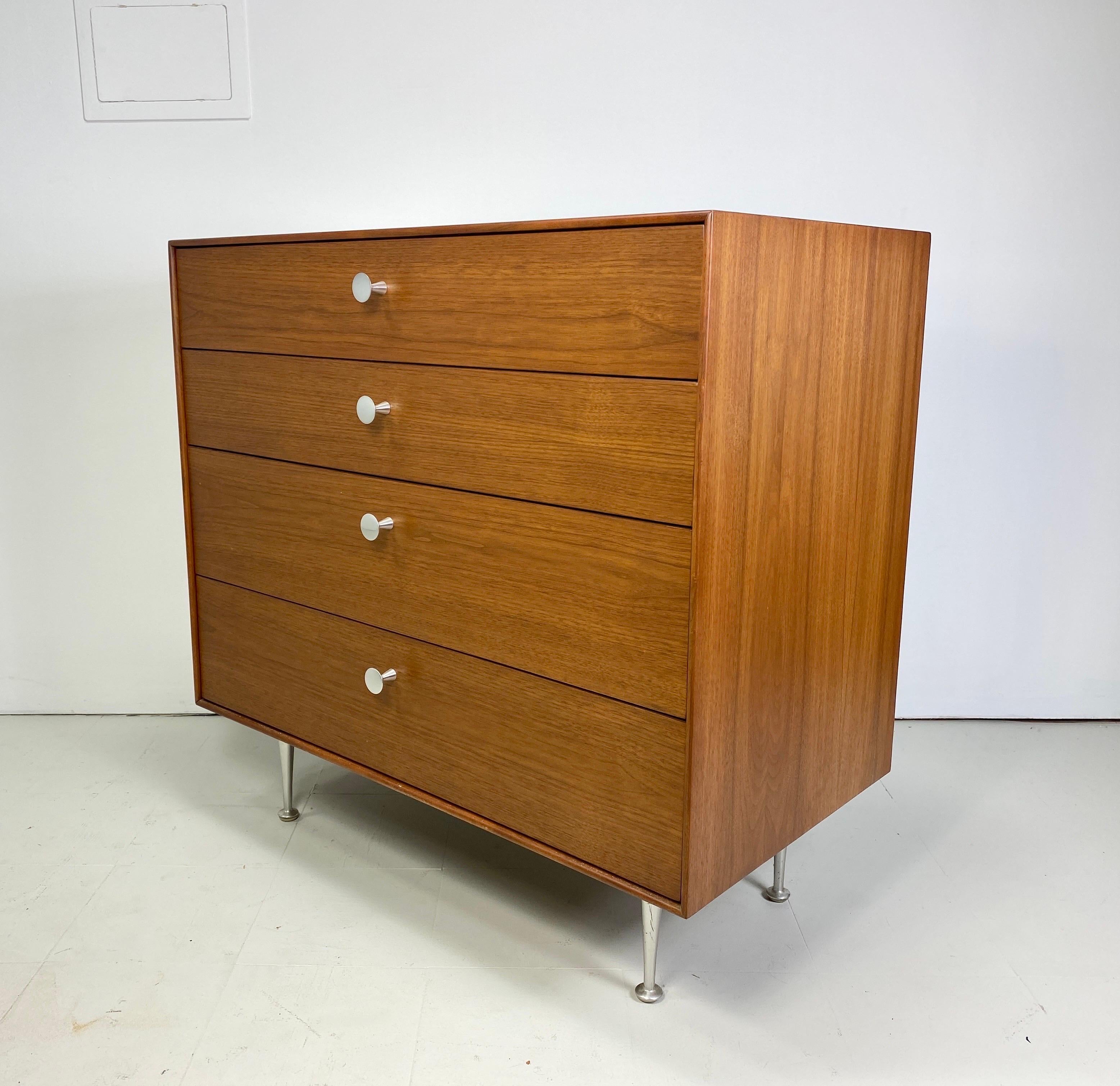 George Nelson for Herman Miller Walnut Thin Edge dresser. Dresser features aluminum legs and pulls. Original hang tags sold with cabinet. 1960s