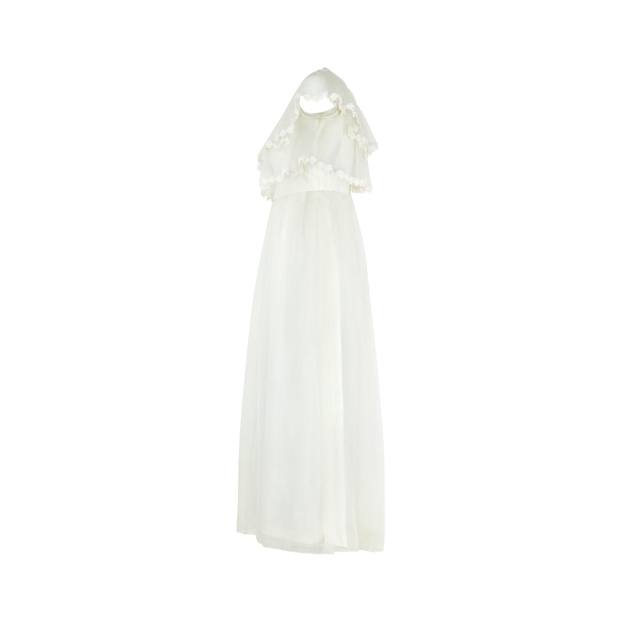 I'm almost certain that this is a late 1960s wedding dress by Jean Varon who's designer, John Bates, was one of the best British fashion designers of his day and retailed at Harrods. With its sleeveless cut and wide boat-neck, this pretty summer
