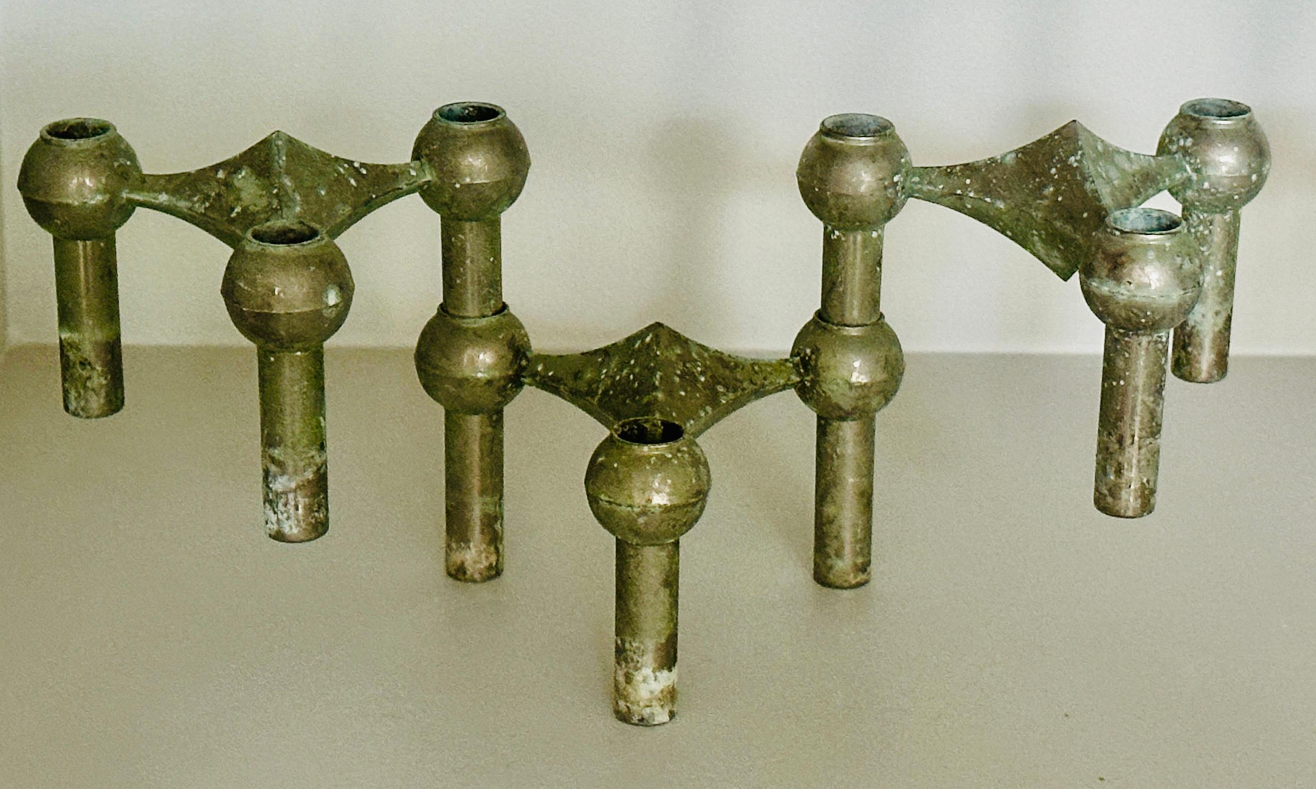 1960s Brutalist interlocking candle holders designed by Fritz Nagel and Ceasar Stoffi for BMF Nagel in Germany. The candle holders hold thin candles and can be combined in atomic-like structures. The more you combine the more intricate your uniquely