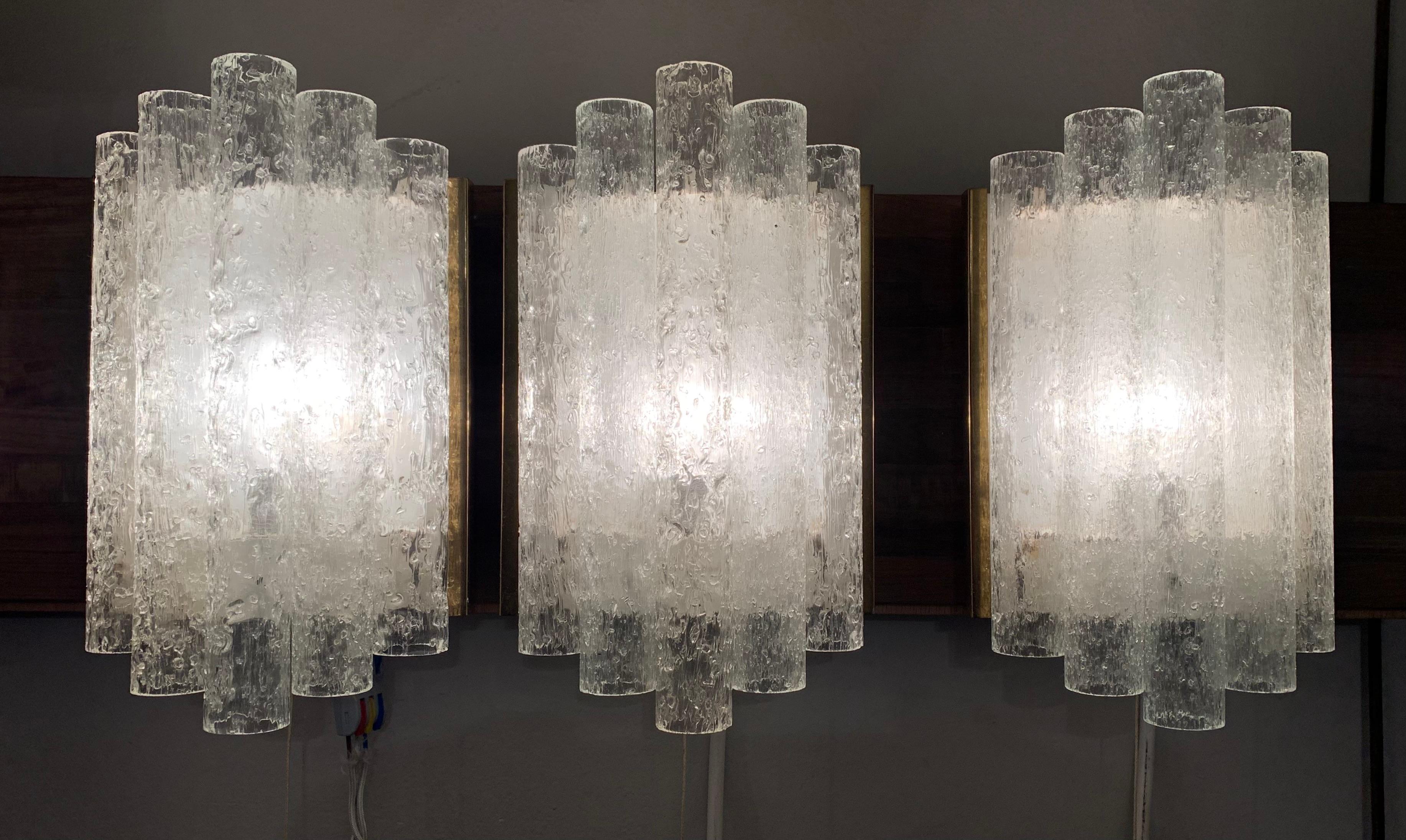 1960s wall sconces/wall lights with vertical ice-glass frosted tubes positioned at varying heights at either side of a single central longer tube. Manufactured by Doria Leuchten in German during the 1960s. Each tube has a small hole which allows