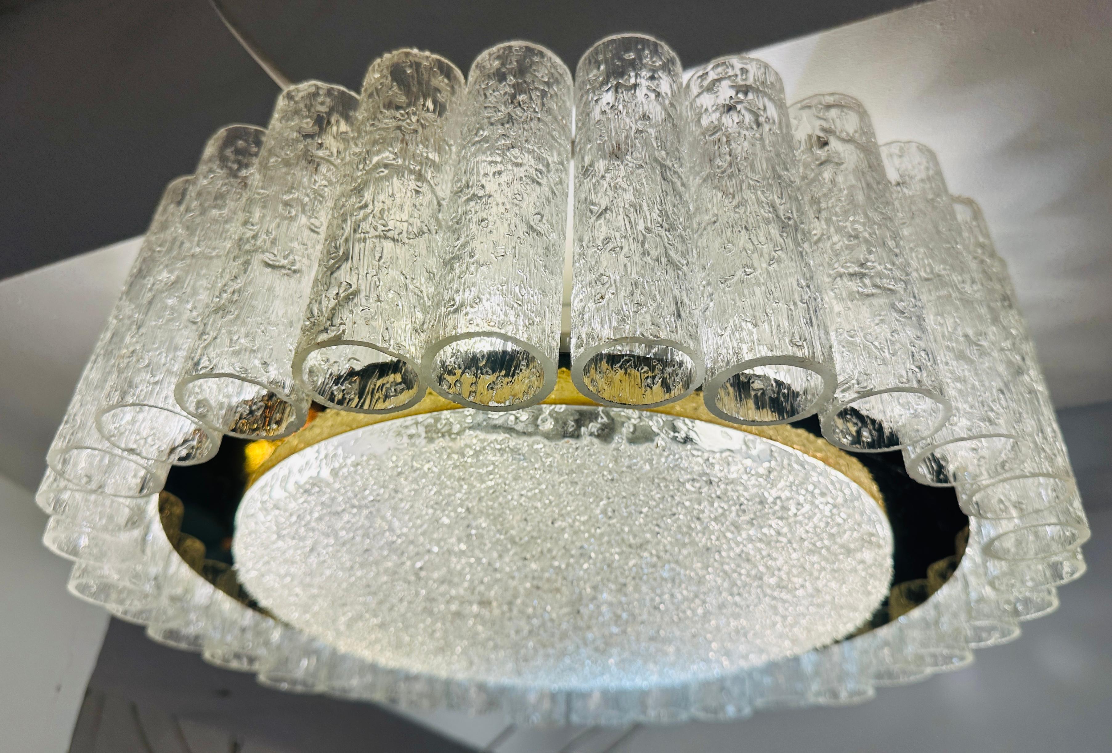 A striking 1960s German Doria Leuchten flush mount ceiling light.  The light features 32 textured, crystal glass tubes, suspended from a white metal lacquered frame, surrounding a crystal glass textured horizontal disc secured inside a polished