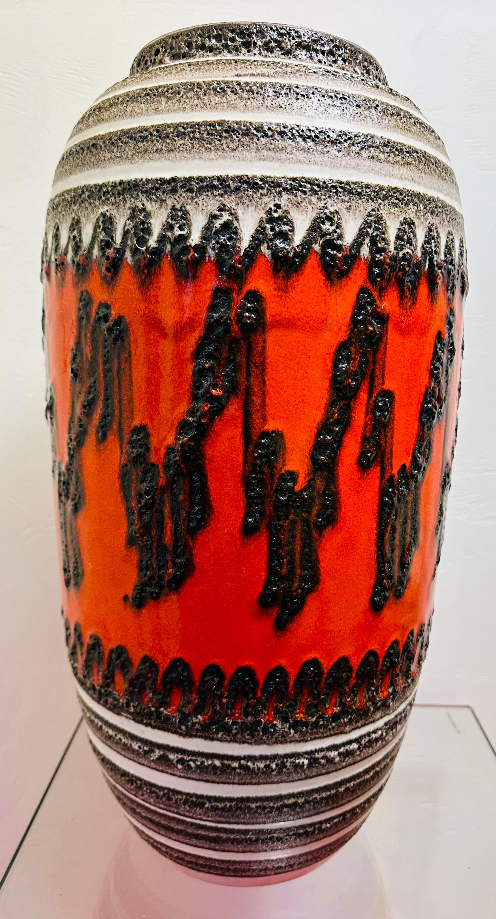 An extra large and striking fat lava floor vase dating from the 1960s/70s. Manufactured in West Germany by Scheurich. Model number inscribed on the base: 546-52 W. Germany.

A multi-coloured fat lava matt and gloss glazed floor vase in bright orange