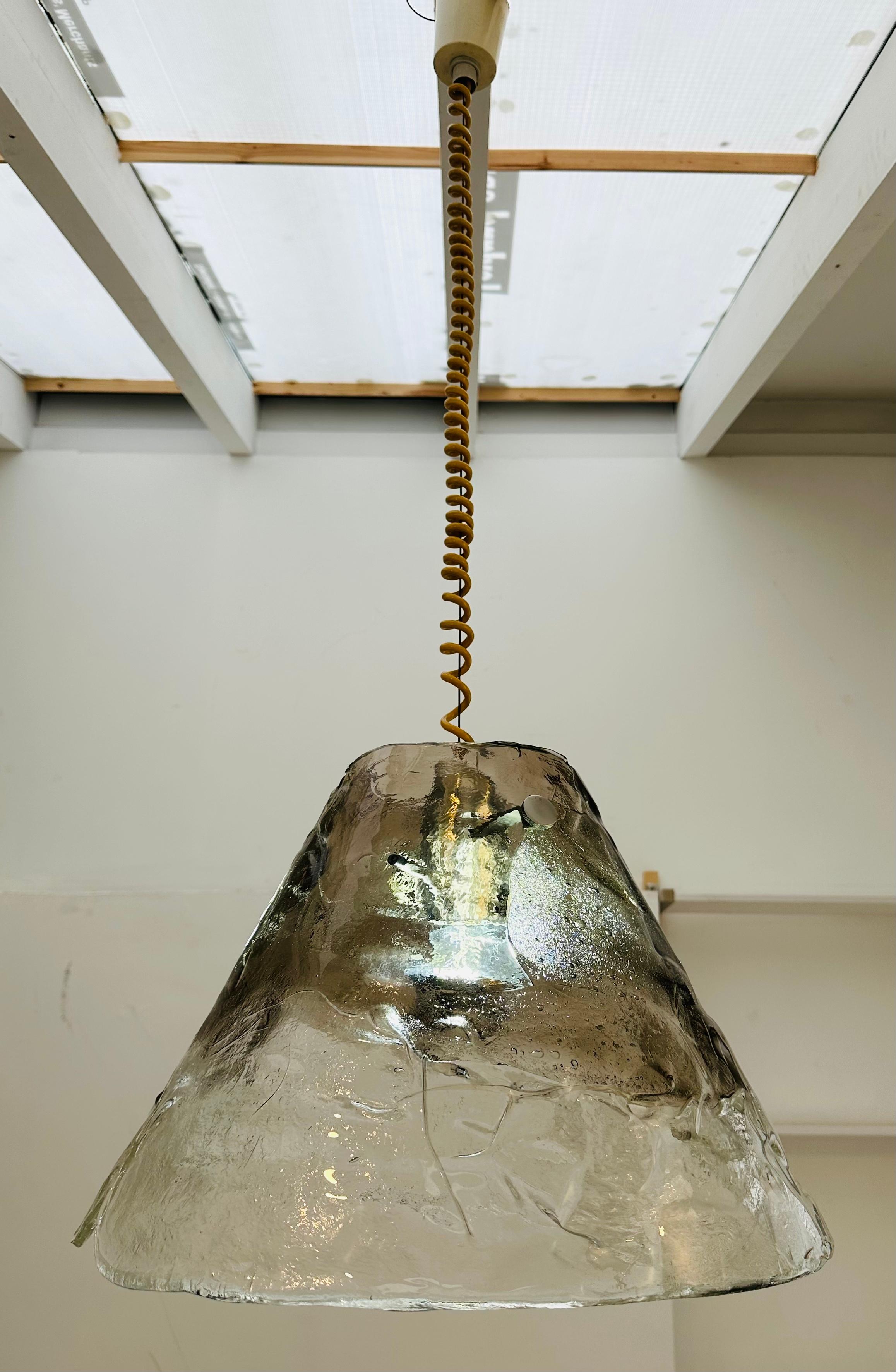 An absolutely stunning mid century 1960s smoked and clear glass hanging pendant light designed by J.T. Kalmar for Franken KG.  Manufactured in Germany.  The shade is formed with two pieces of heavy textured Murano glass which are a smoked brown
