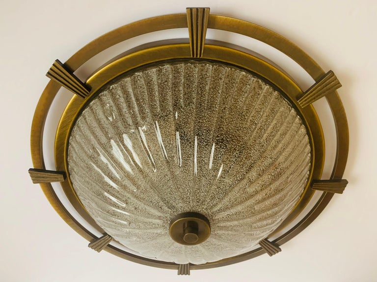 An aged brass nautical style German flush light with a hand blown Murano glass shade, 1960s. Rewired. 3-light sources.