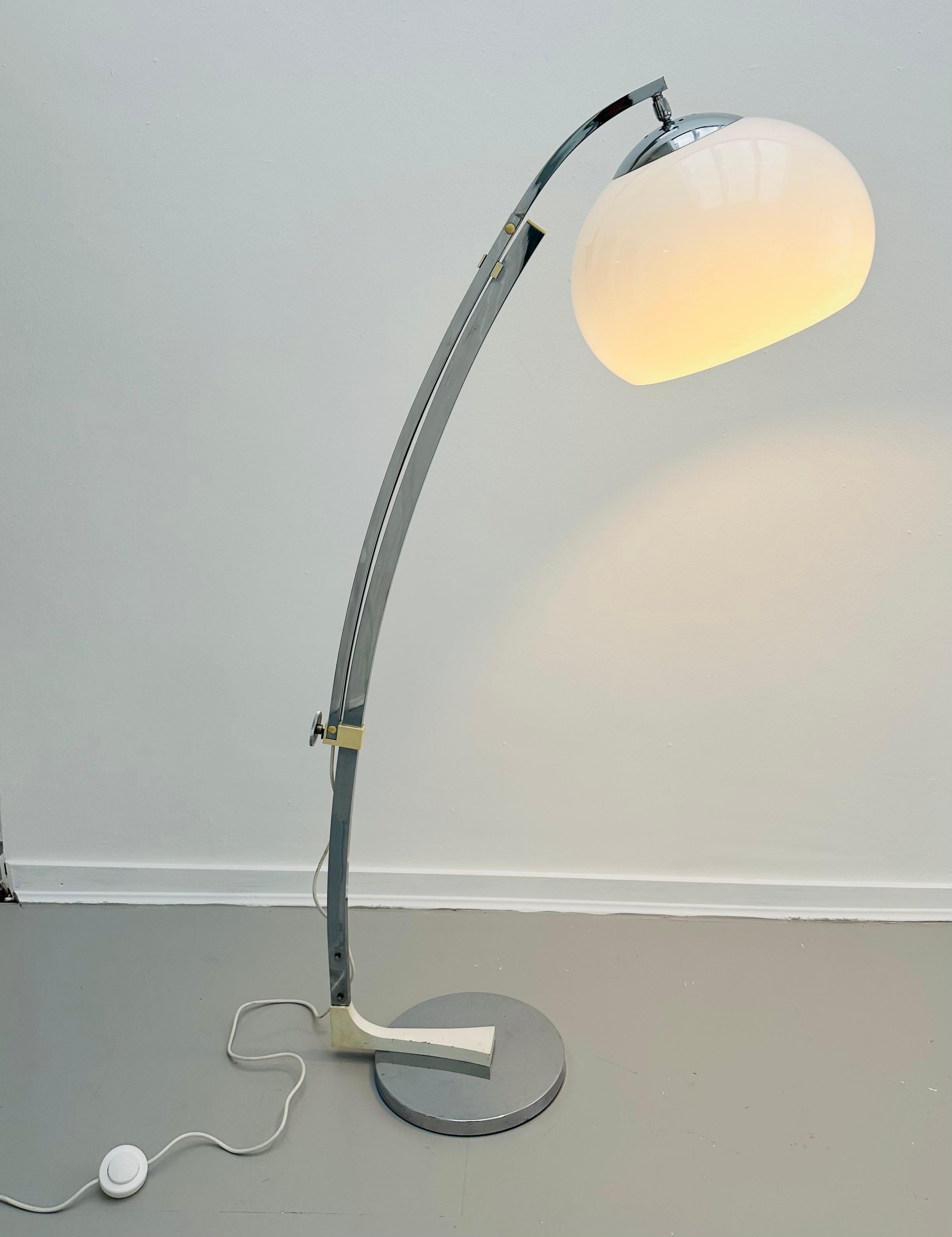 1960s German space-age, adjustable, polished chrome arc floor lamp manufactured by Sölken Leuchten. The height is adjustable and held in place by a large feature chrome screw knob which slides up and down the lower metal supporting section which is