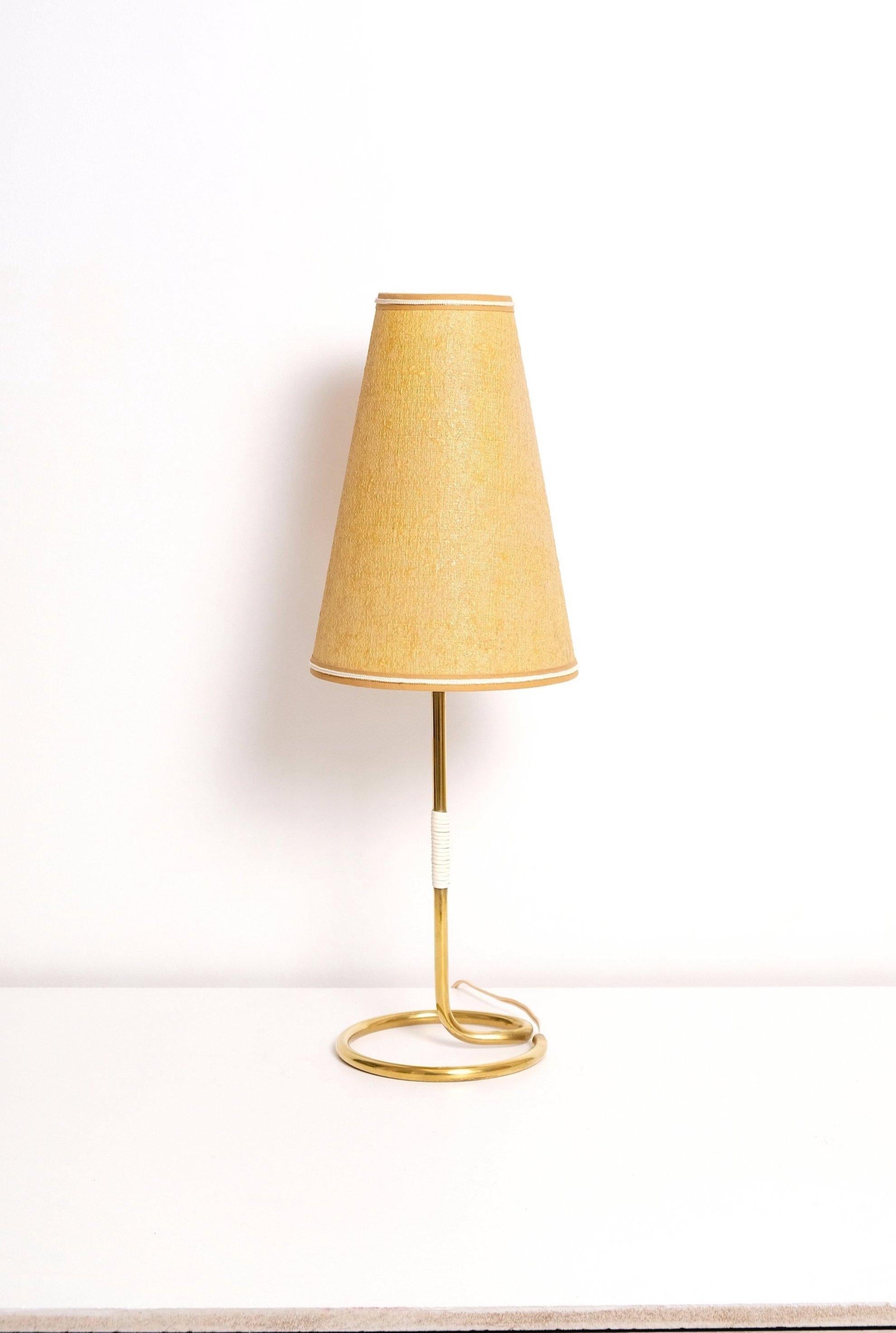 Table lamp made in German. Polished brass stem and foot, paper backed cloth shade. 40-60 watts E-26 Edison medium base incandescent bulb recommended or higher if LED/CFL.
Rewired with new E-26 medium base socket and rewired with 18/2 plastic cord,
