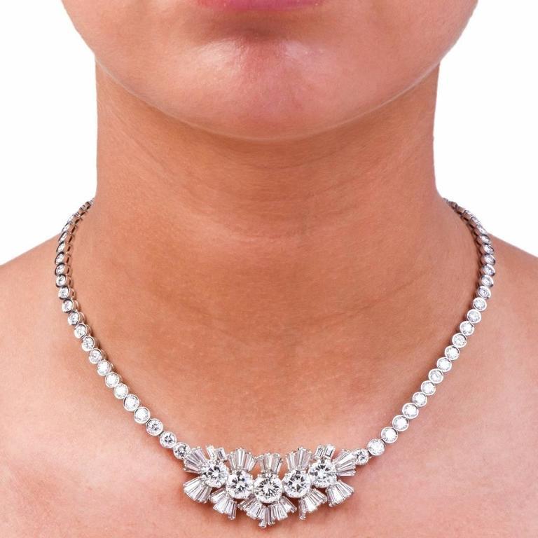 This alluringly feminine and classically elegant estate diamond necklace is crafted in solid 18K white gold. Incorporating a central decor simulating 5 flowers, it is centered with 5 genuine round brilliant cut diamonds cumulatively weighing 7.80