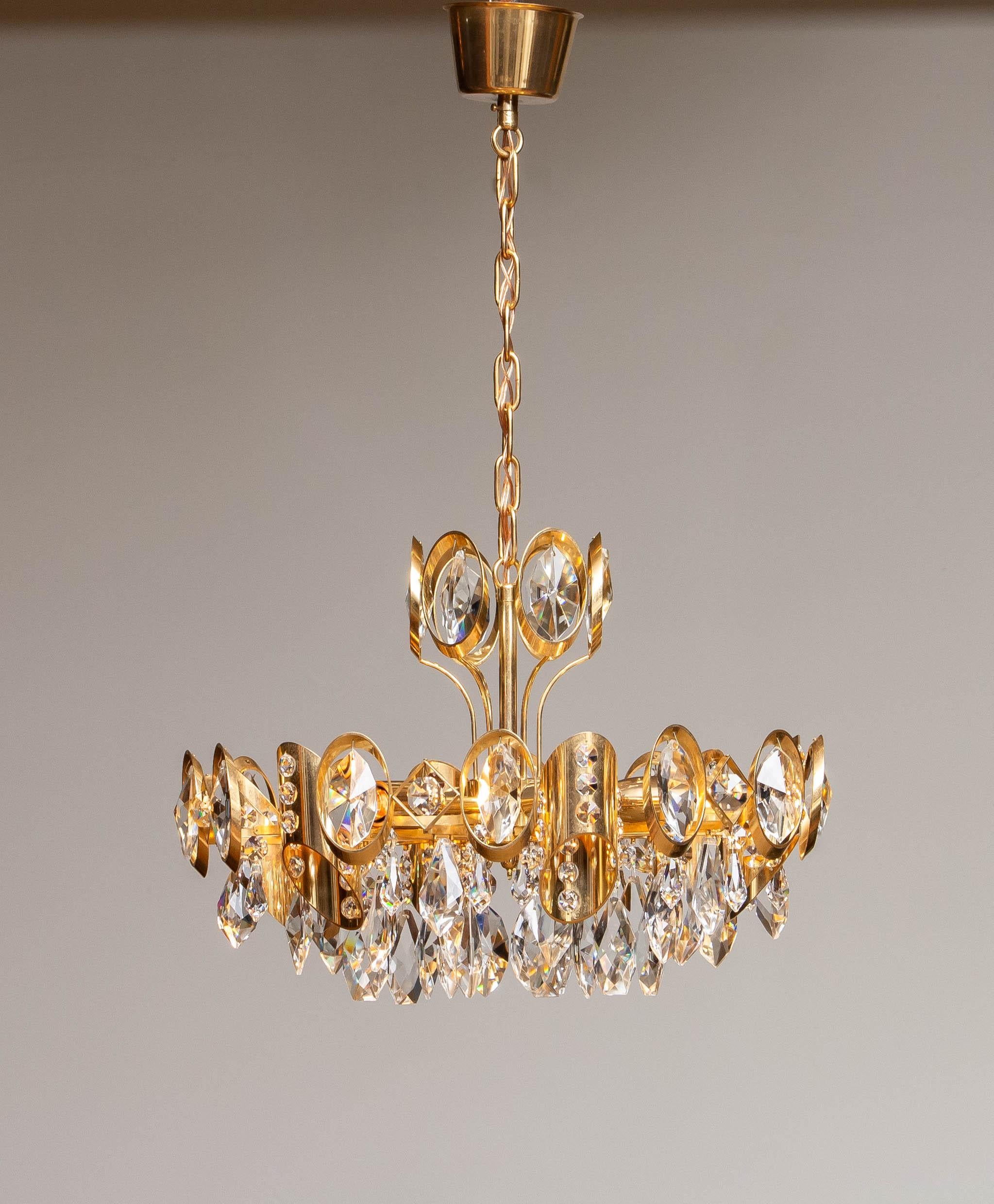 Beautiful high quality gilt brass fixture filled with stunning faceted crystals by Ernest Palme for Palwa Austria.
This chandelier consists six E14 / E17 screw fittings for 110 or 230 volts. Technically 100% and in overall good condition.
The given
