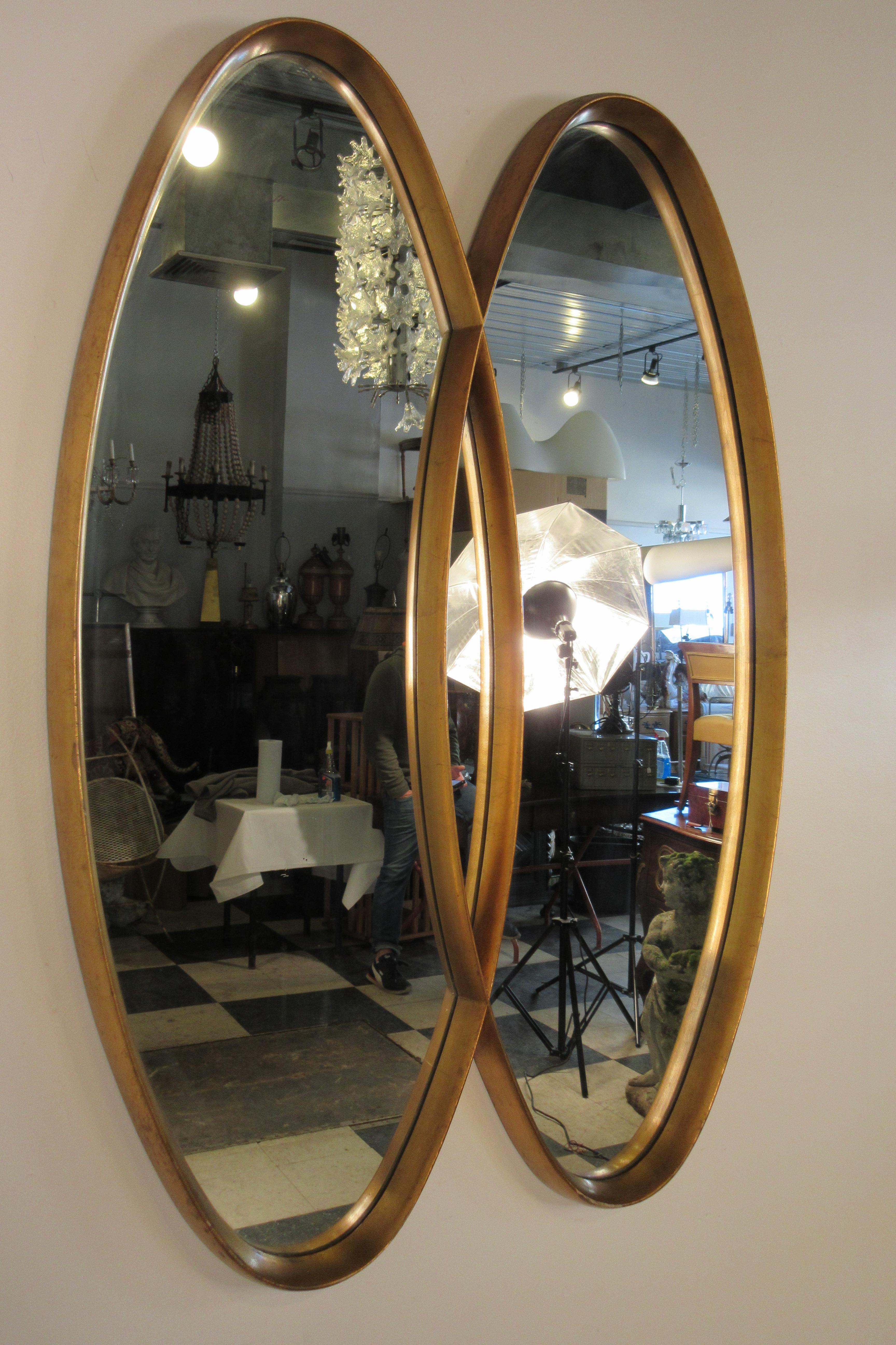 Deep framed 1960s gilt oval intersected mirror.