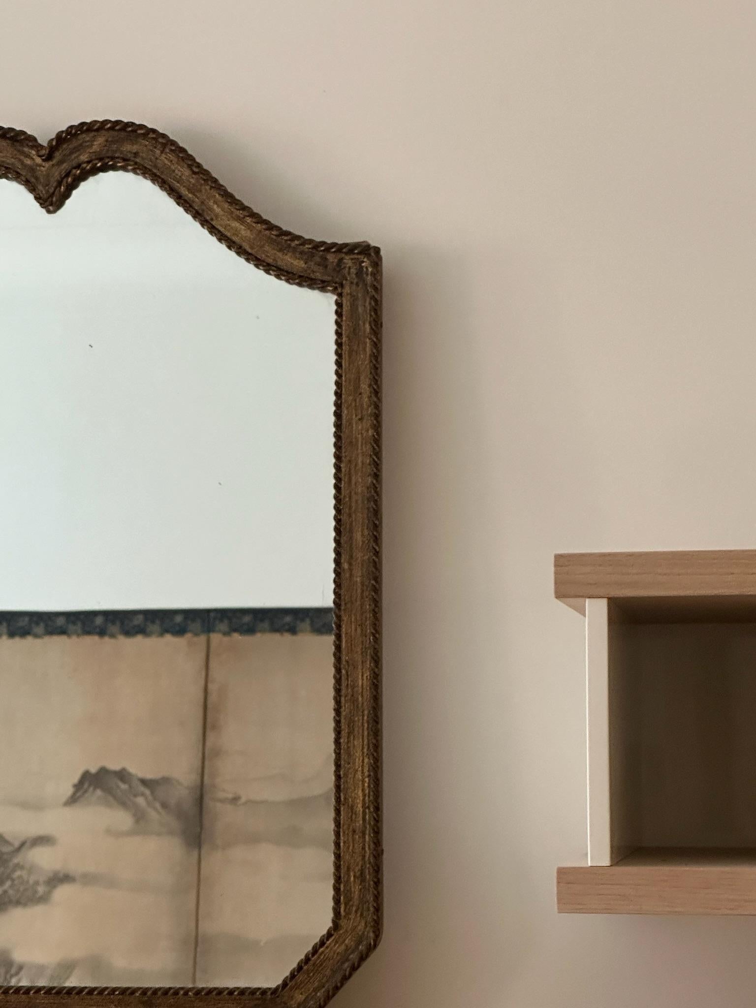 Beautiful gilt mirror with bronze roping on the edges, circa 1960. Sourced in Paris.