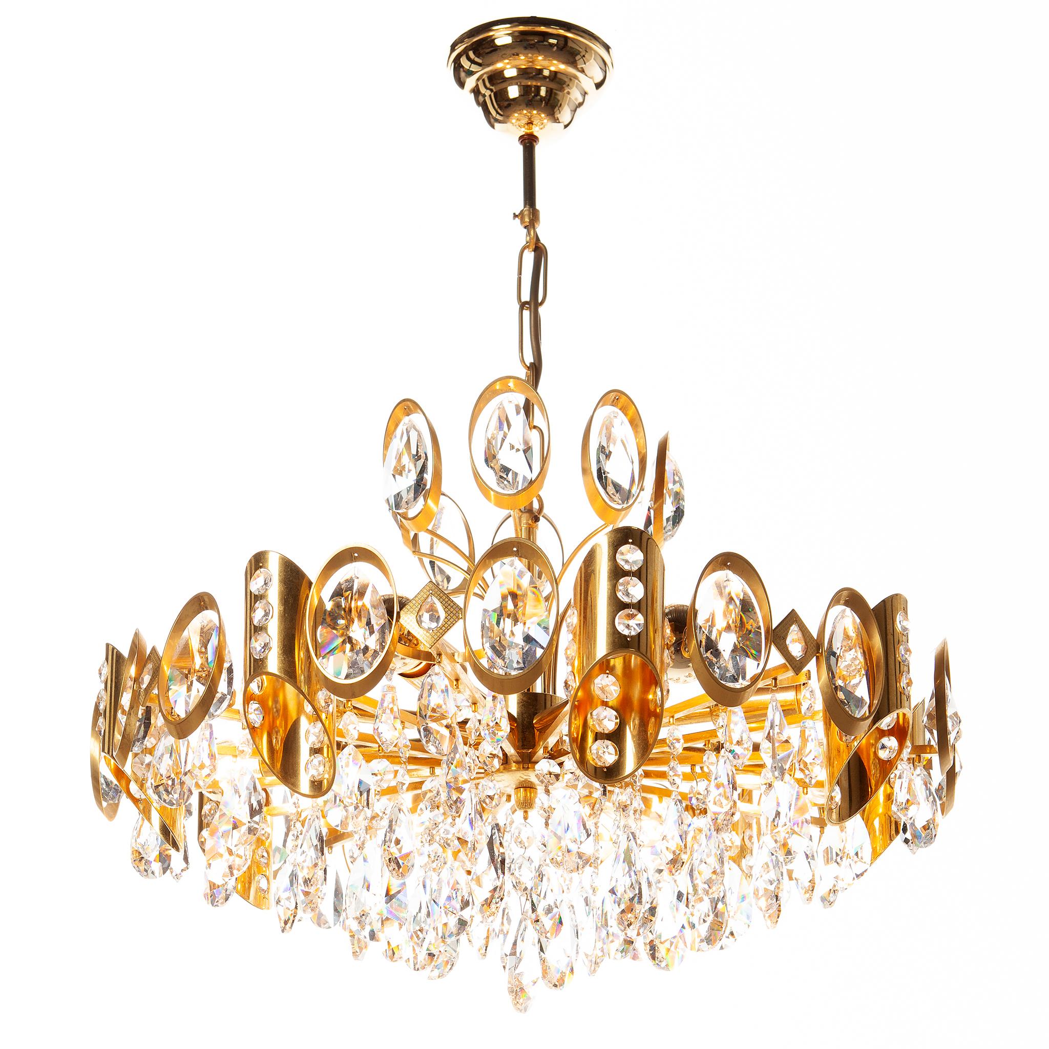 An elegant chandelier by Palwa made in Germany in the 1960s. Multiple gilded brass tier design and asymmetrical cylinders, with cut crystal pendants with beaded crystal accents. 

The light requires eight E14 light bulbs.