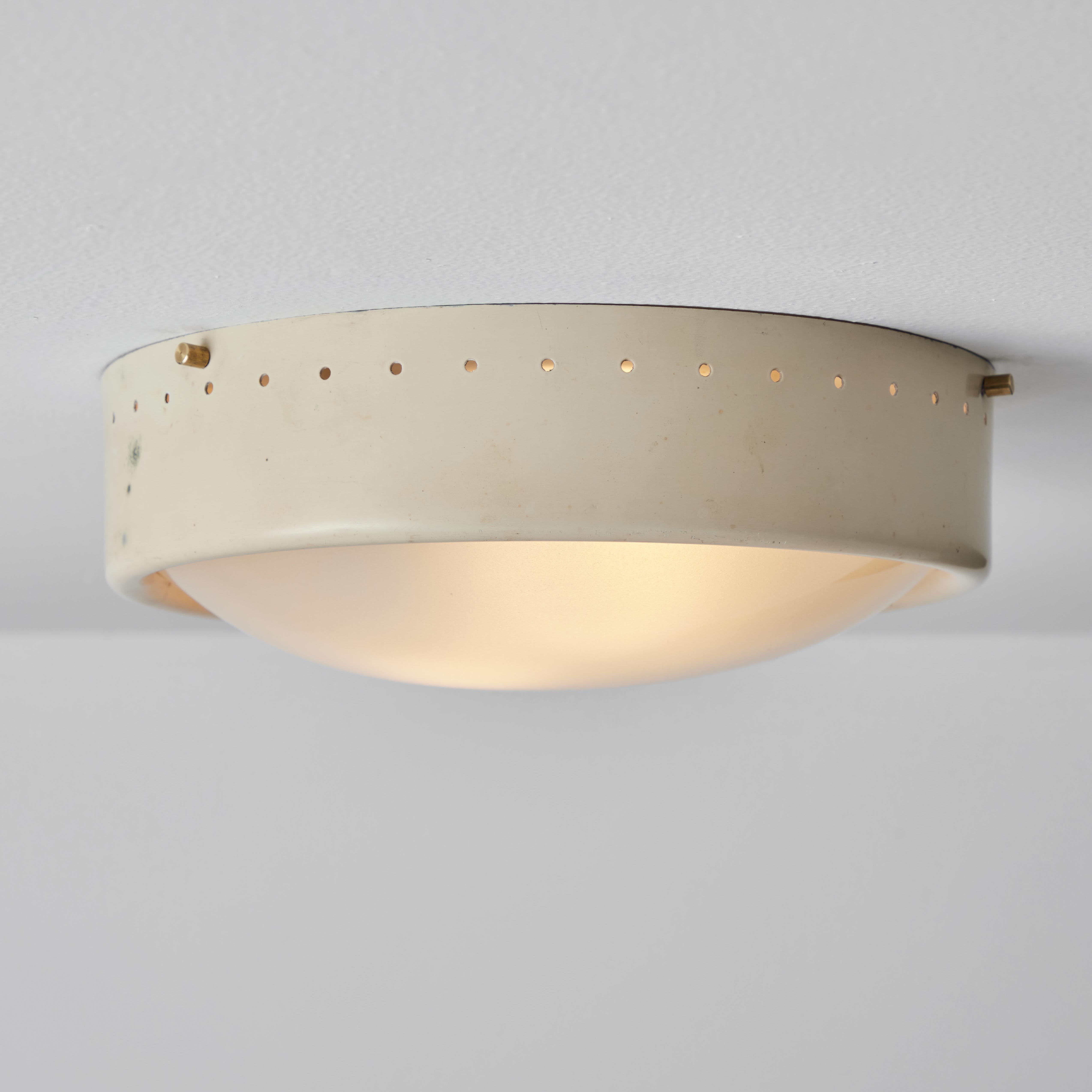 1960s Gino Sarfatti Perforated metal and opaline glass flush mount for Arteluce. Executed in curved opaline glass and painted perforated metal. The simplicity of Sarfatti's design and the sculptural shaping of the materials make for an incredibly