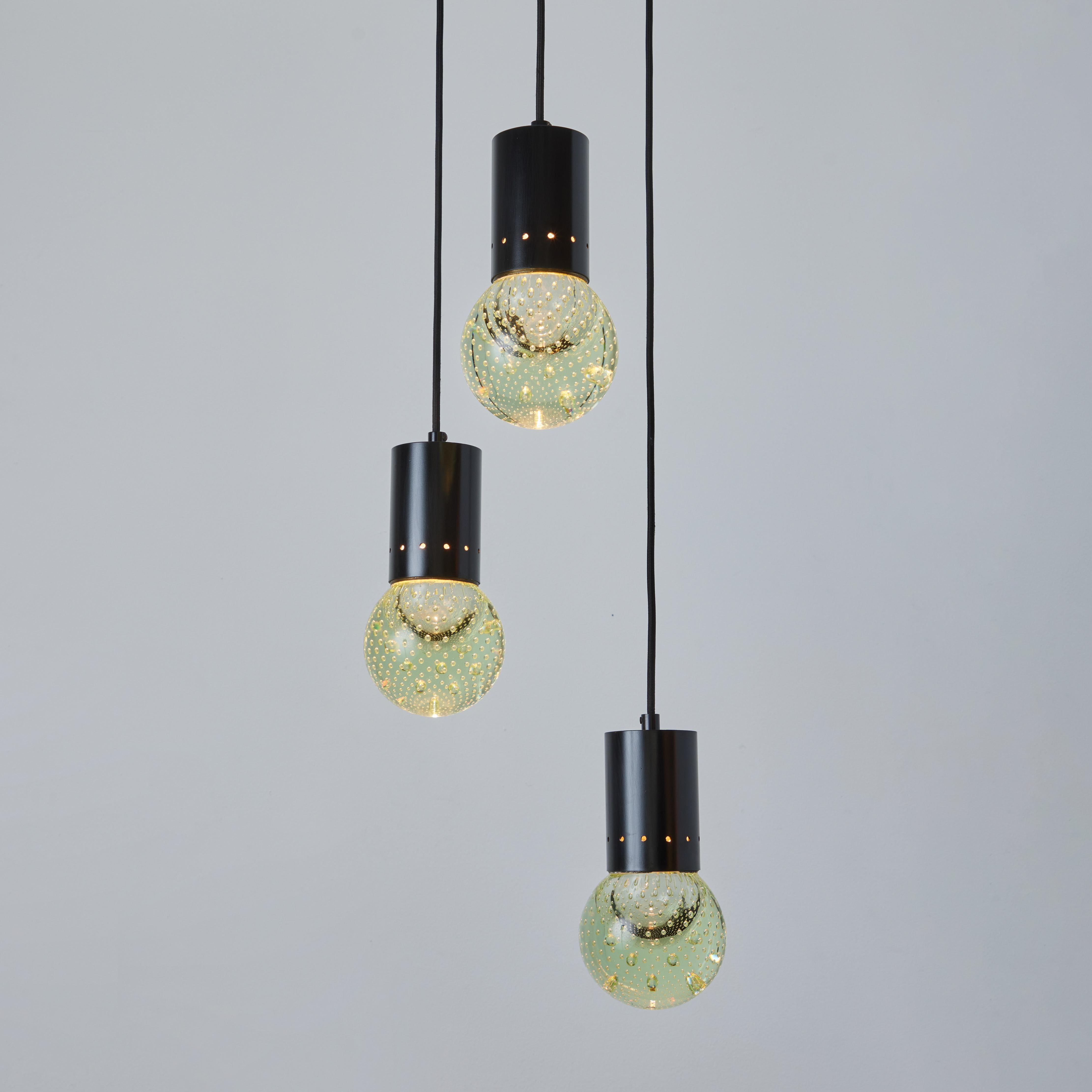 1960s Gino Sarfatti Seguso Bubble Glass 3-Pendant Chandelier for Arteluce. Executed in 3 hand blown bubbled Seguso glass pendants with brass and black painted metal accents. The simplicity of Sarfatti's design and the sculptural shaping of the
