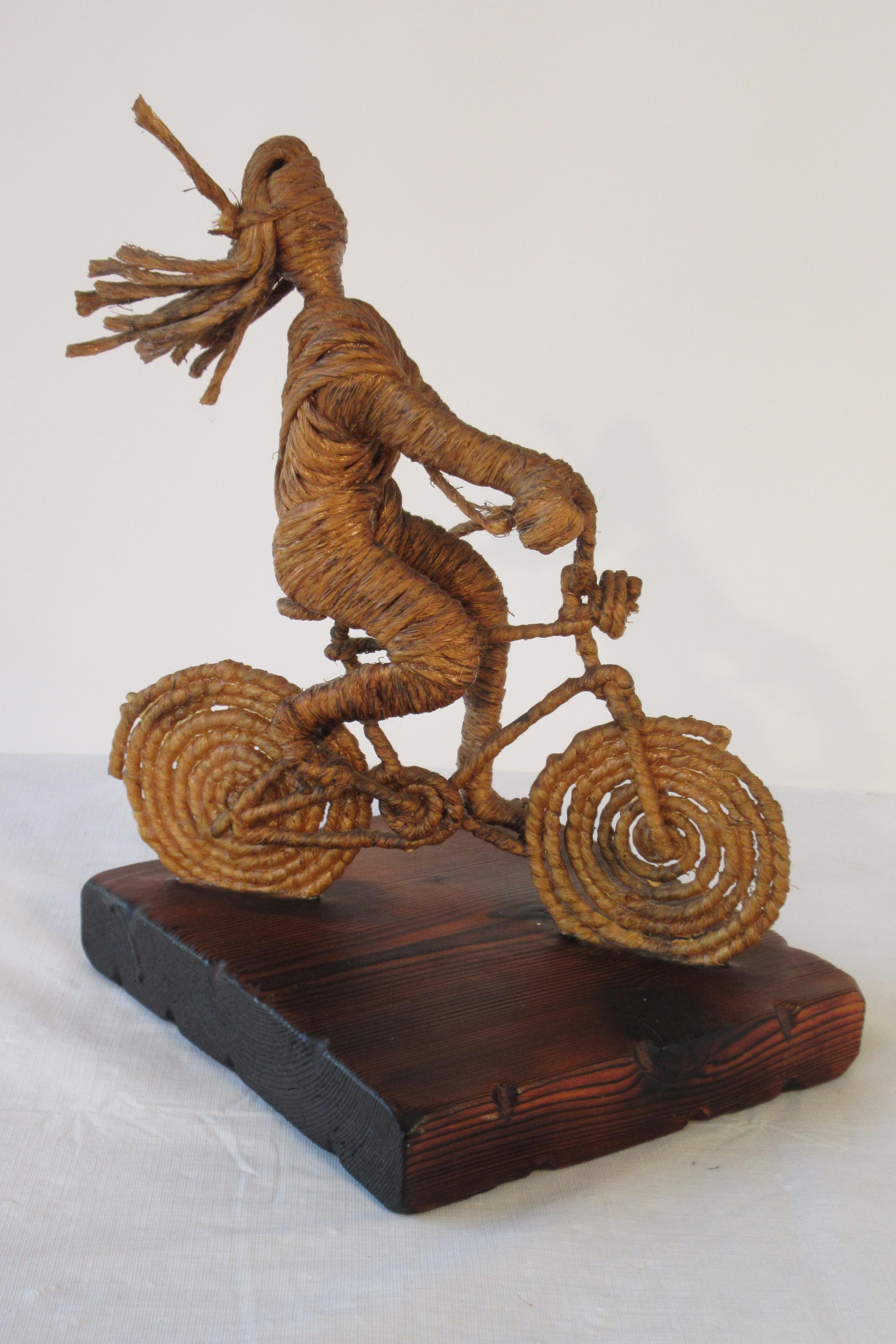 1960s girl on bike sculpture made from rope.