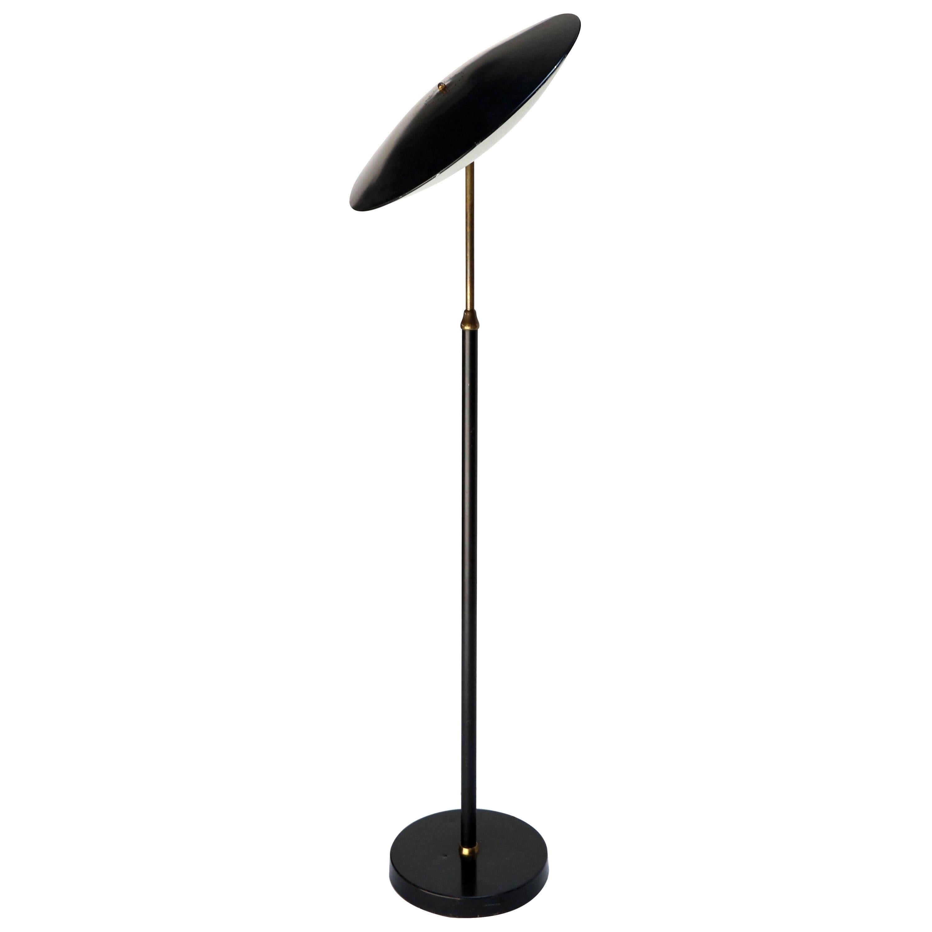 1960s Giuseppe Ostuni Italian black metal floor lamp, with white underside. Head rotates and moves in all directions.