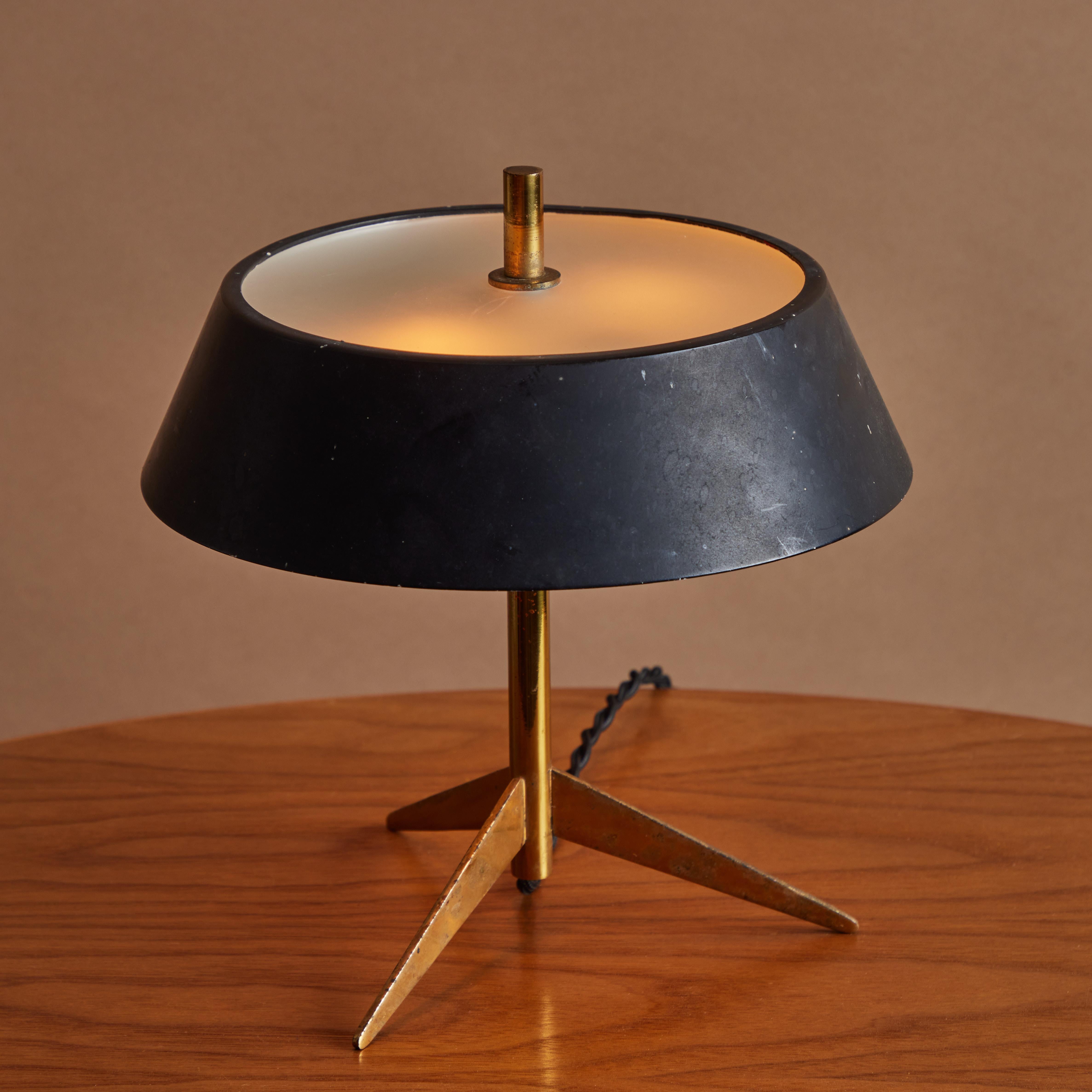 1960s Giuseppe Ostuni metal and glass tripod table lamp for O-Luce. An extremely rare and surprisingly versatile design executed in black painted metal and brass with an opaline glass diffuser by one of the most refined Italian designers of the