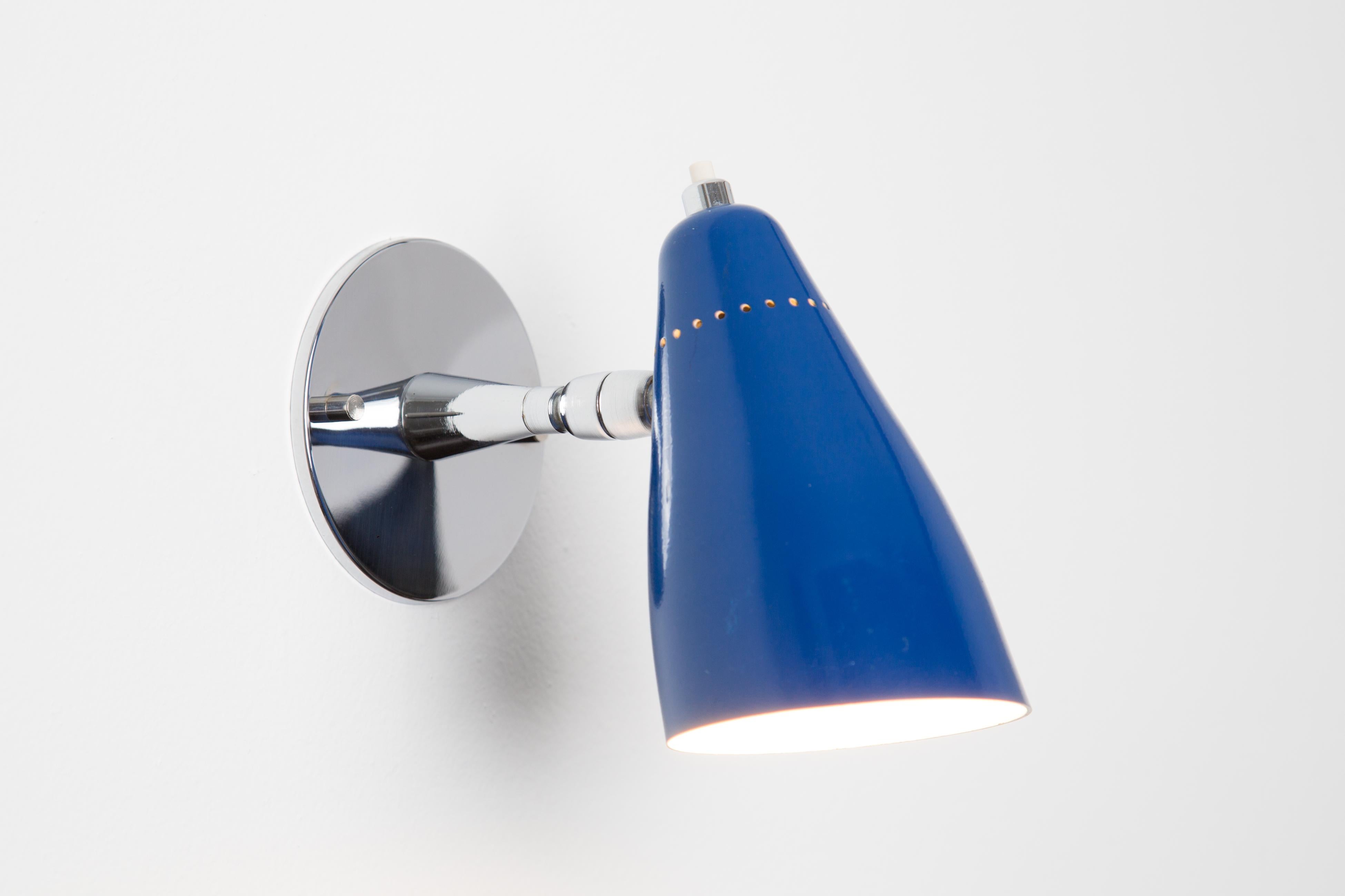 1960s Giuseppe Ostuni Model #101 Blue Articulating Sconce for O-Luce. Executed in polished chrome and a blue painted perforated aluminum shade. Sconce pivots up/down and left/right. An incredibly clean and refined design by one of the Italian