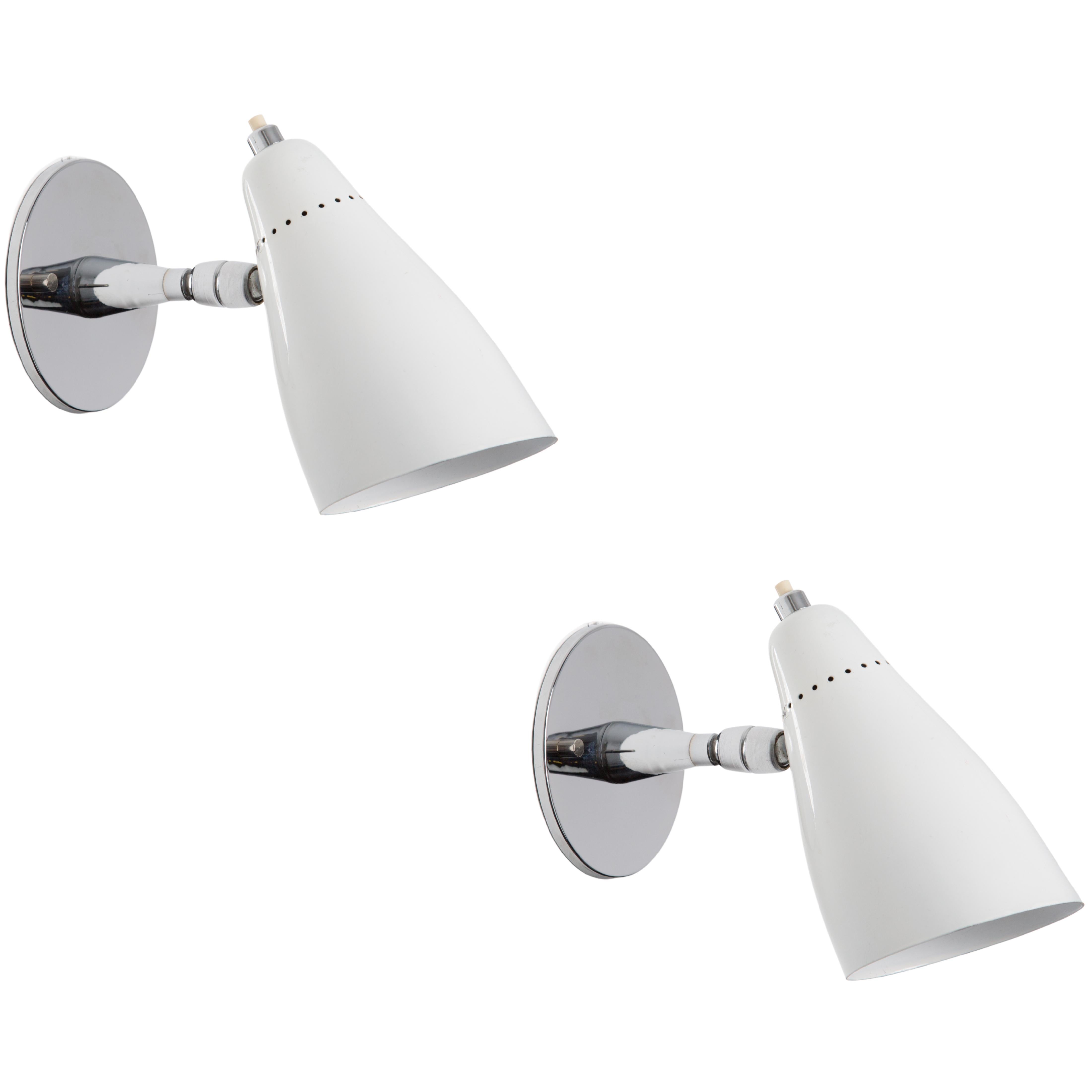 1960s Giuseppe Ostuni Model #101 white articulating sconce for O-Luce. Executed in polished chrome and a white painted perforated aluminum shade. Sconce pivots up/down and left/right. An incredibly clean and refined design by one of the Italian
