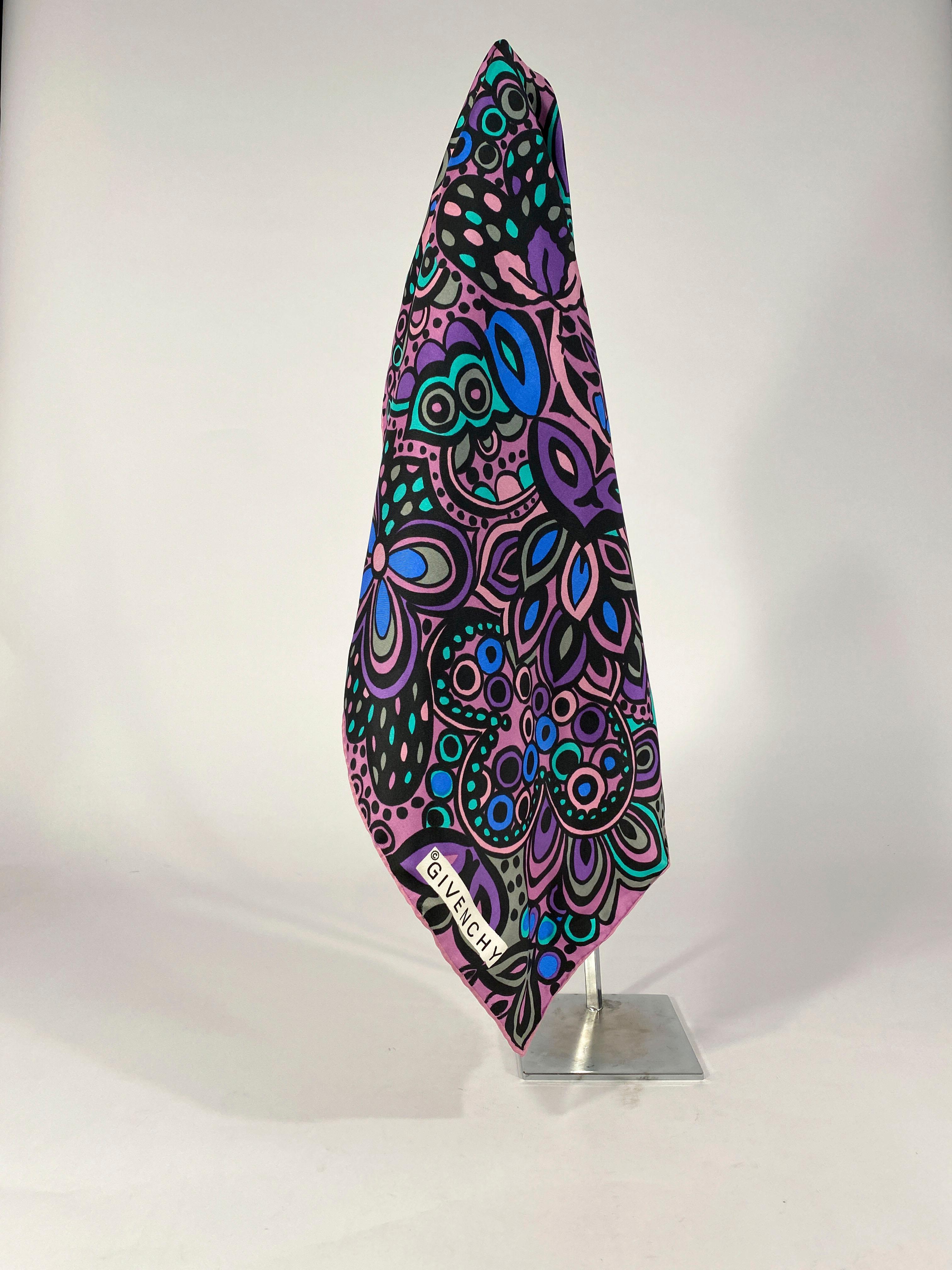 1960s Givenchy silk scarf featuring a psychedelic whimsical print in teal, blue, black, grey, and several shades of purple and lavender. The edges are hand-rolled.