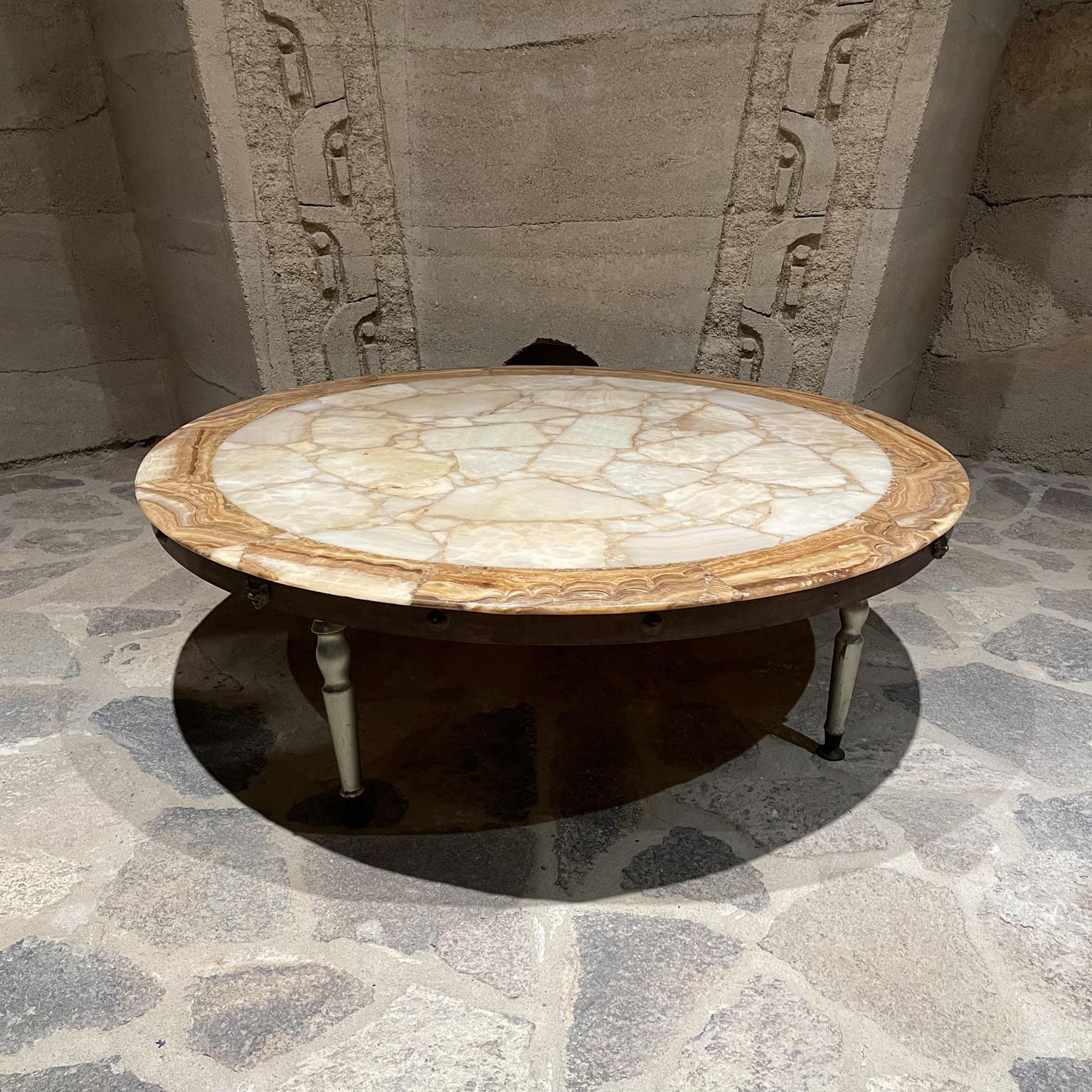 Stone coffee table
Made by Muller of Mexico Glamorous Modern round onyx stone coffee table 1960s sculpted wood legs brass sabots.
Preowned vintage condition. Tabletop has been restored, new satin finish.
Legs have patina present. Unrestored
