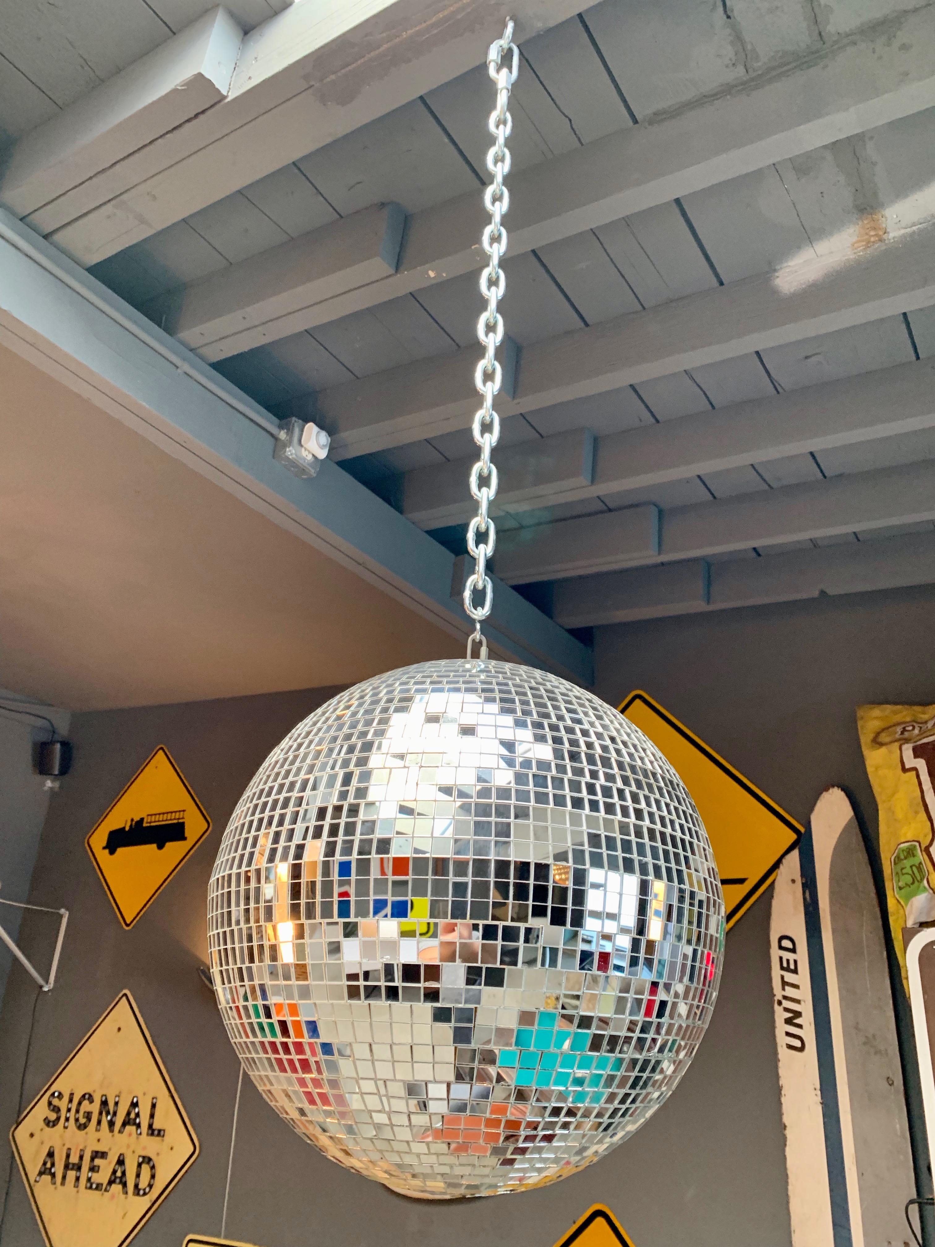 Great retro disco ball made out of square pieces of glass. Great condition. No missing pieces. Illuminates beautifully. Hanging on metal chain. Can adjust overall height before shipped out.

Measures: Diameter of ball is 15.5