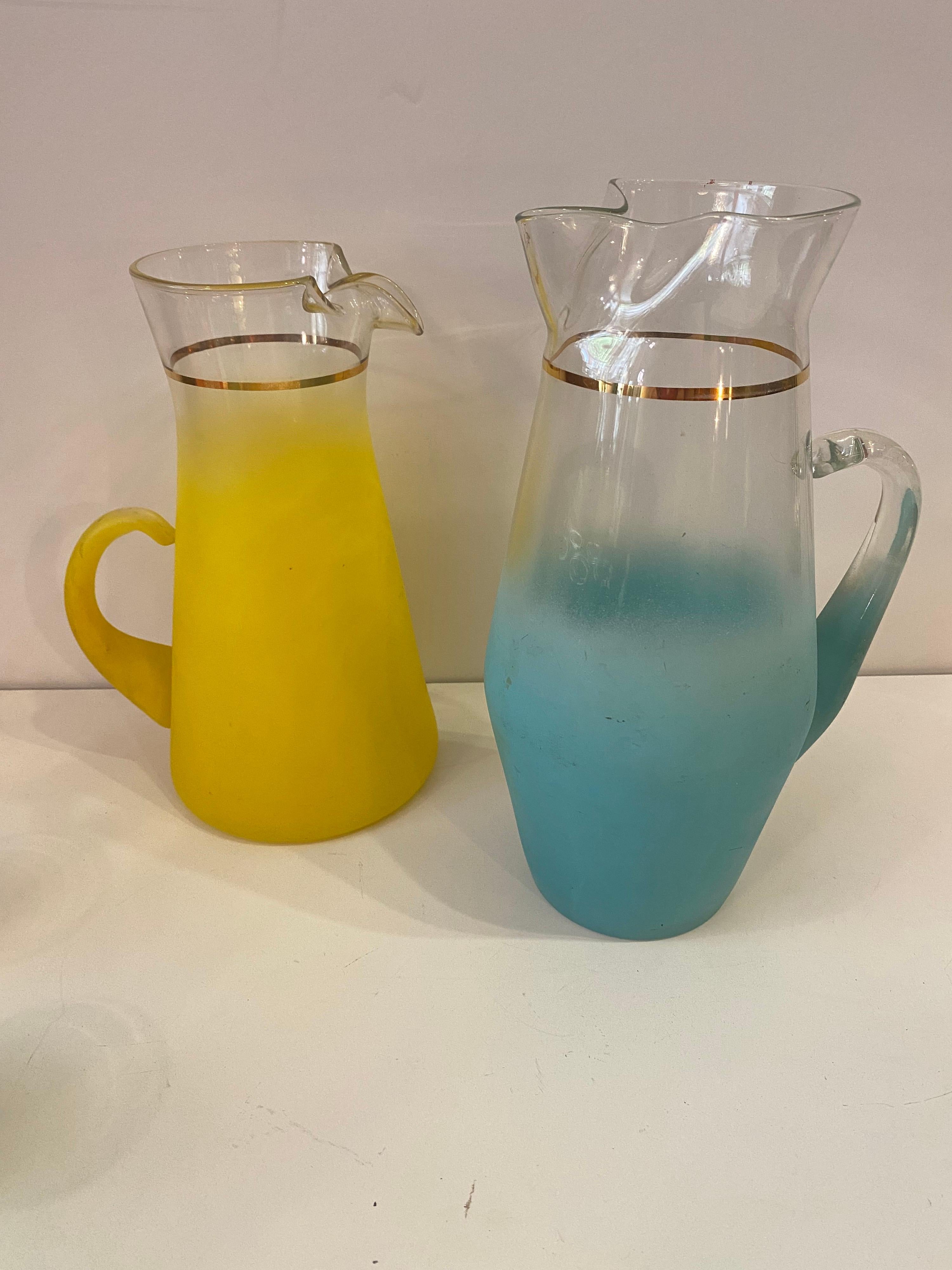 1960's drink glass set, 2 pitchers and 6 glasses. Nice bright colors with a gold band around rims! Add a little zip to that drink! Glasses measure 5.5 high.