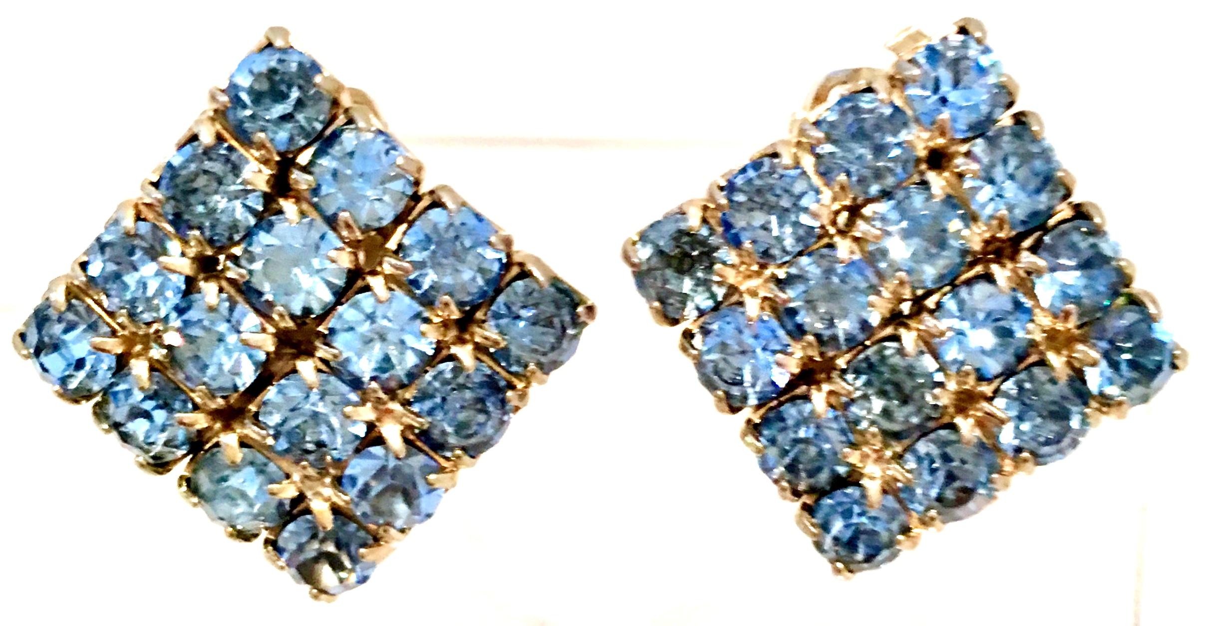 1960'S Gilt Gold Tone Metal & Blue Sapphire Swarovski Crystal Rhinestone Earrings. These clip style prong set earrings feature a triangle shape.