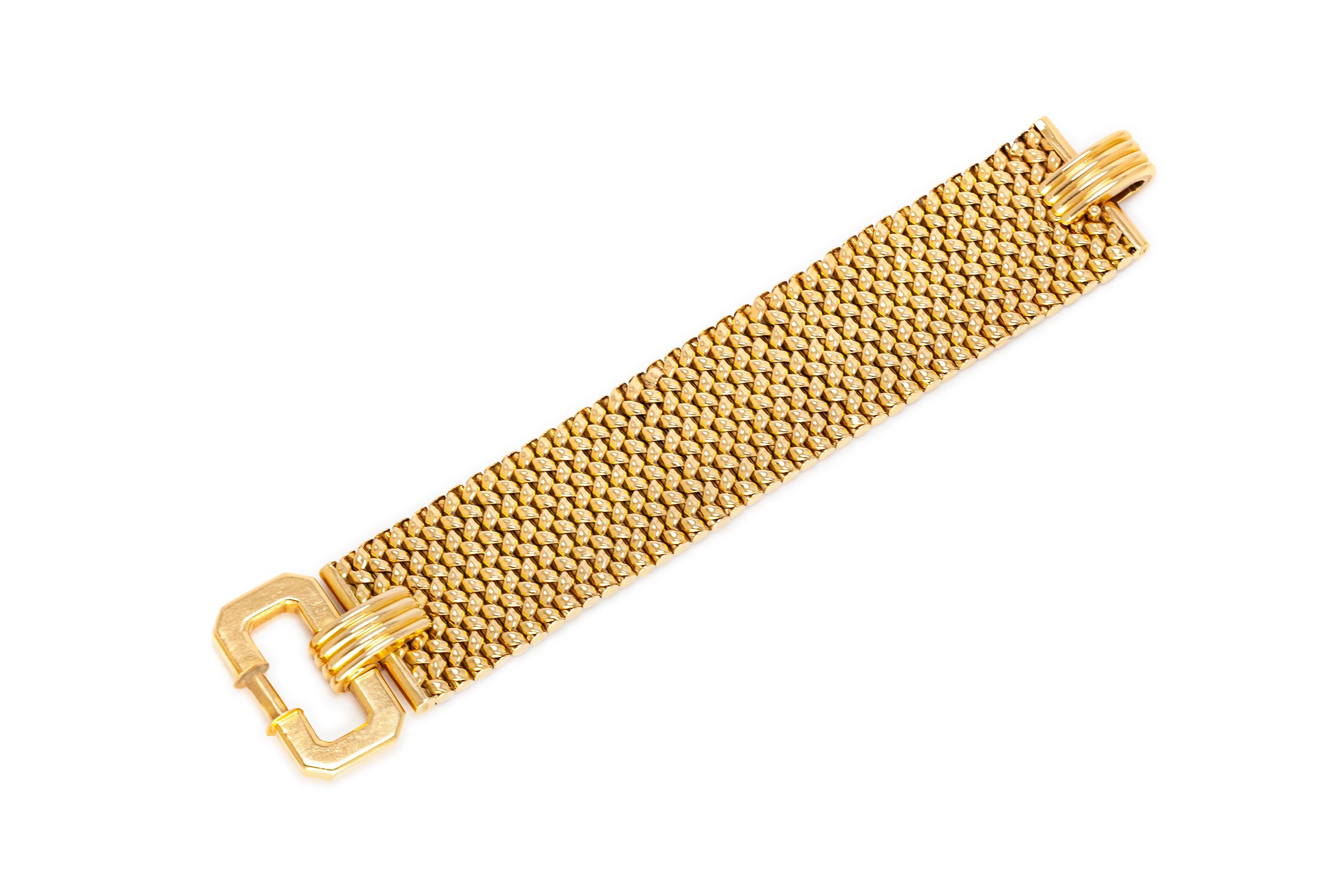 Buckle bracelet finely crafted in 18k yellow gold weighing 54.00 dwt. Circa 1960's. 