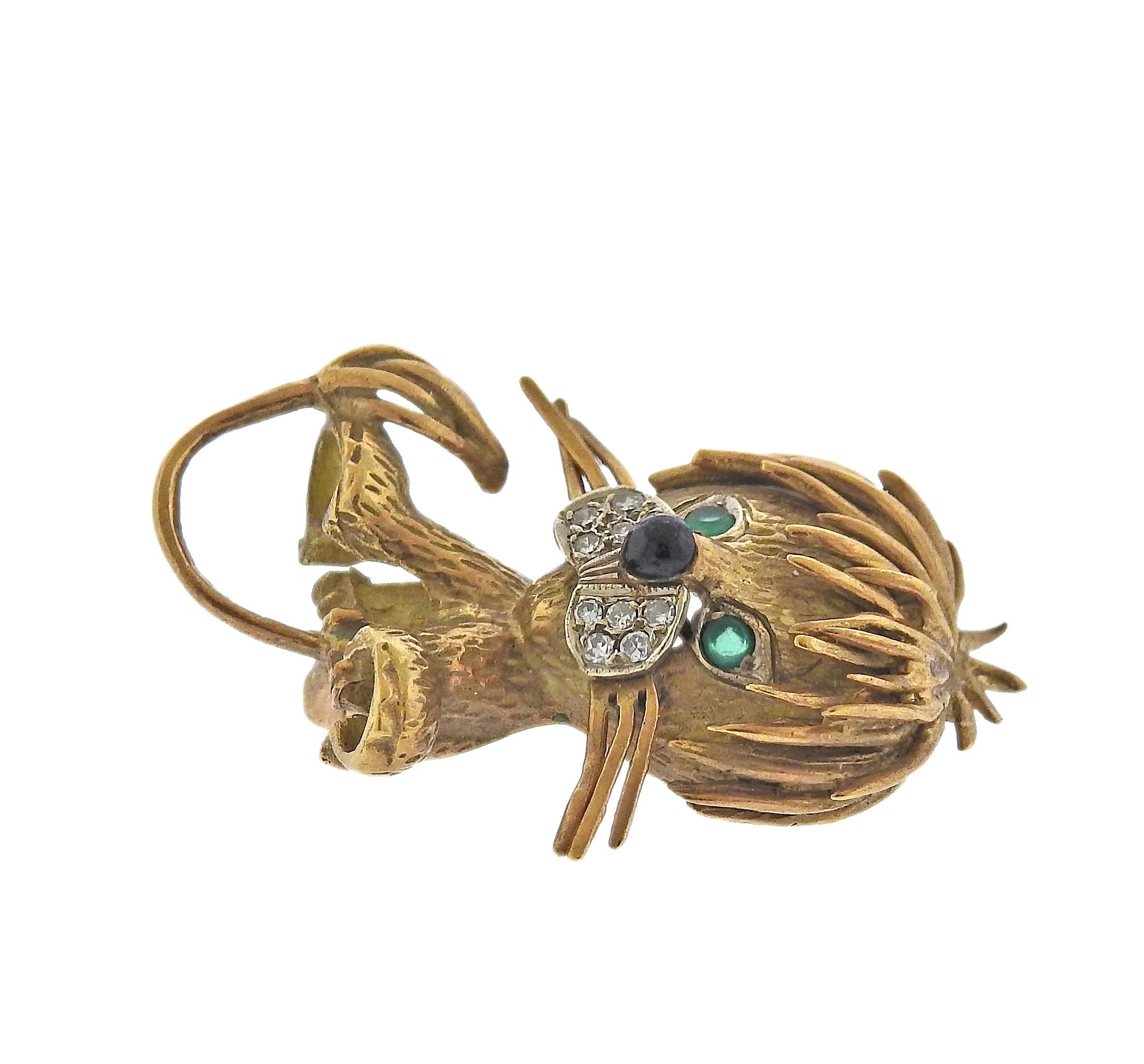 Vintage, circa 1960s 18k gold lion brooch, adorned with diamonds, emerald eyes and onyx nose. Brooch measures 34mm x 22mm. Marked 18k. Weight - 8.7 grams.